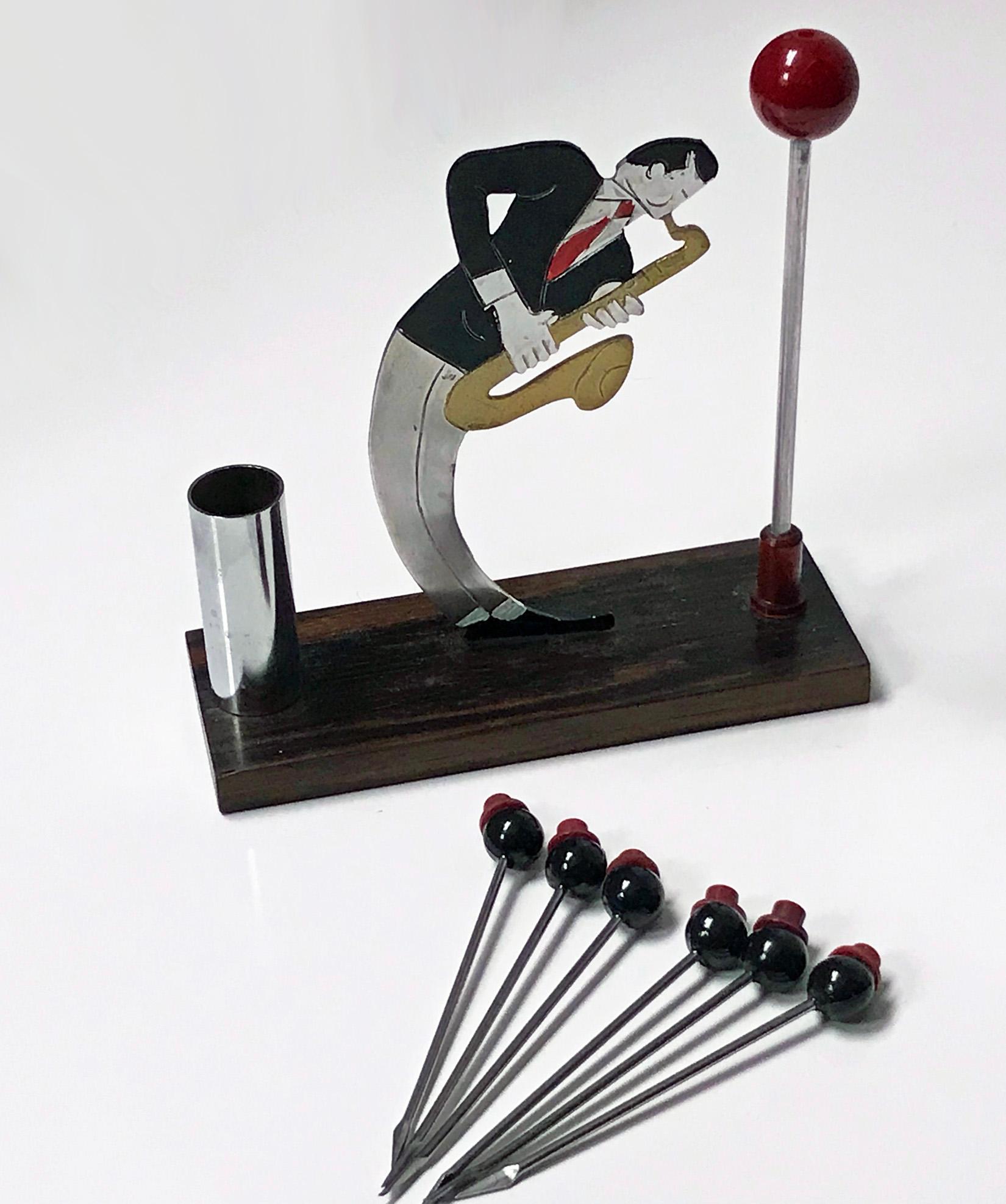 Rare French Art Deco Jazz musician bar cocktail sticks set, probably by Sudre, circa 1920. All mounted on a wood base. The jazz musician playing saxophone, 6 cocktail picks in the form of top hats. Measures: 5.25 x 1.90 x 5.0 inches.