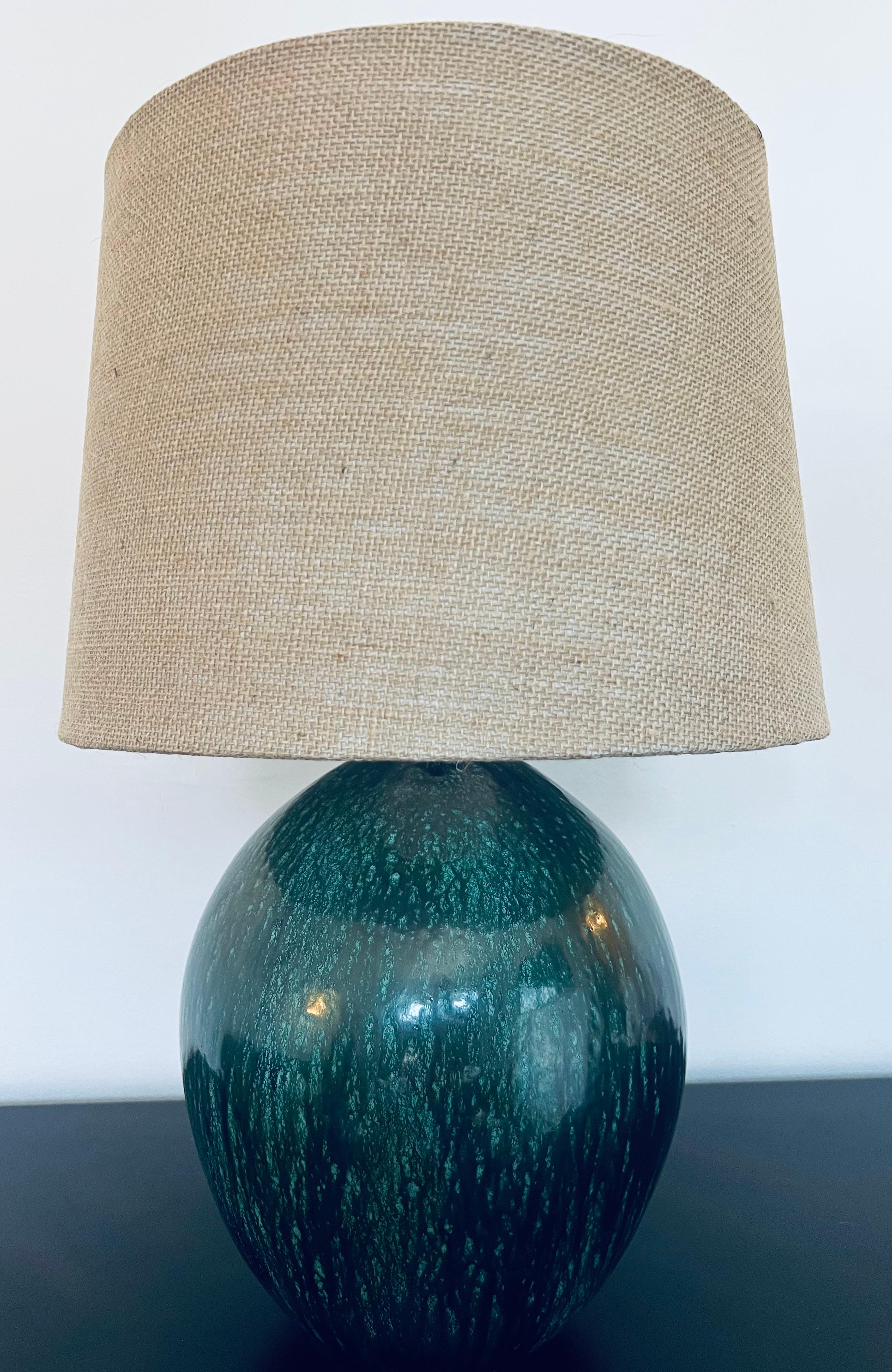 A beautiful large forest green French Art Deco ceramic lamp by Primavera. Rewired with aged brass double sockets and silk cord.