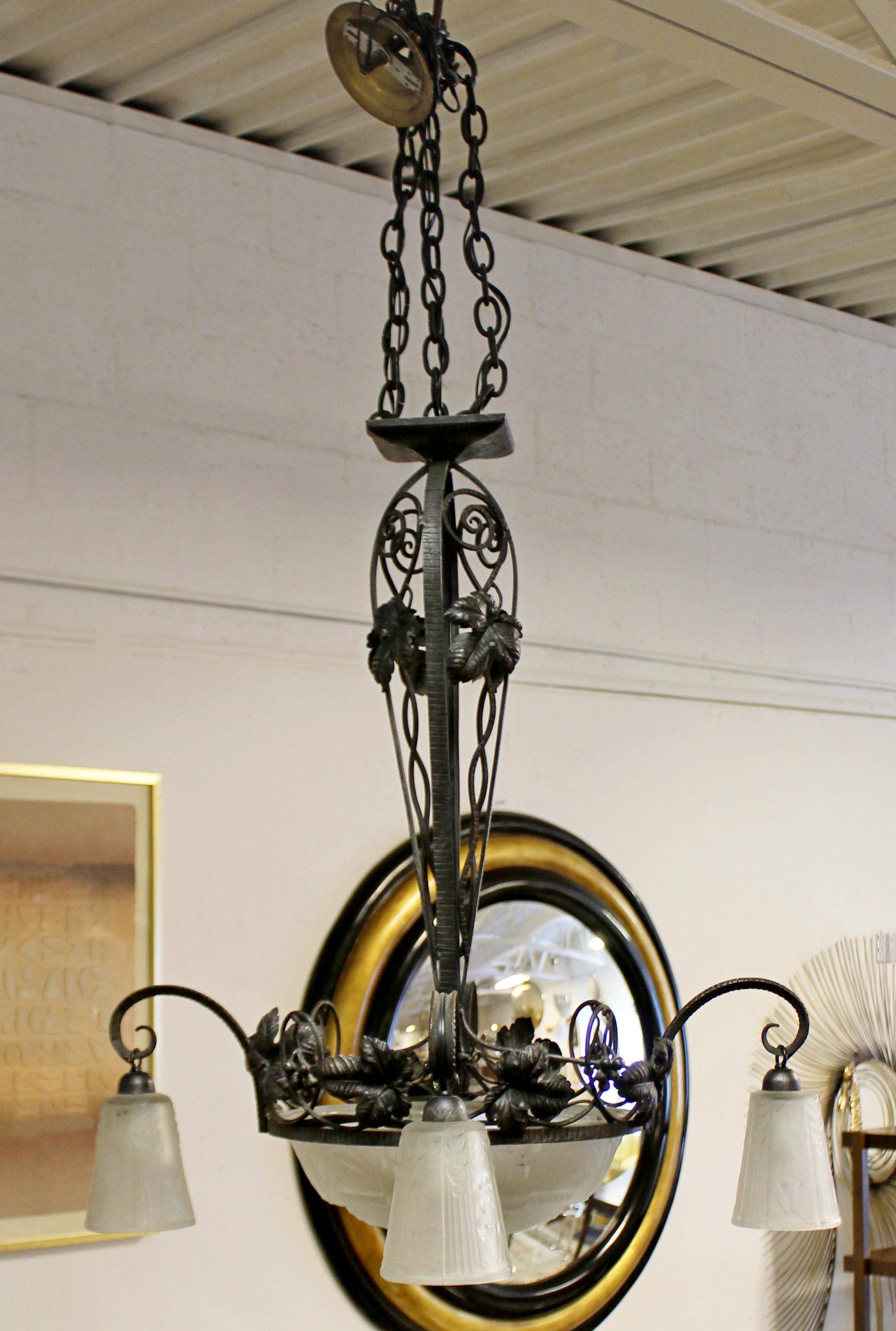 For your consideration is an incredible, wrought iron and glass, hanging light fixture chandelier, by Muller Frères, circa 1920s. In excellent antique condition. The dimensions are 28