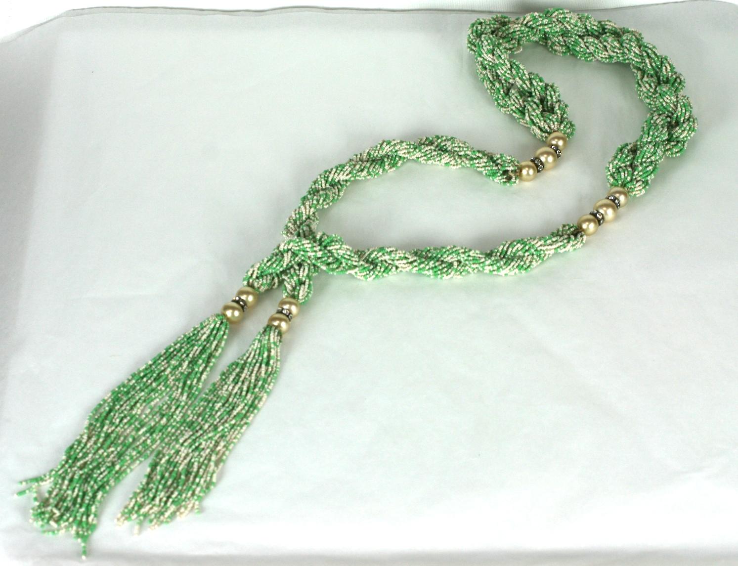 Long French Art Deco 1920s Lariat composed of multi strand, braided twists of opaque faux jade and pearl micro seed beads. 
Beautifully crafted with hand blown glass faux pearl and crystal paste rondelle spacers, terminating with two focal looped