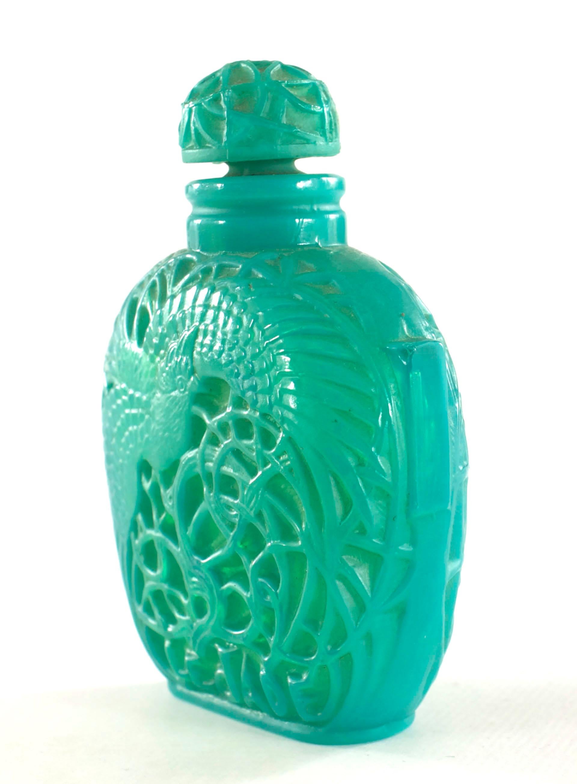 French Art Deco green glass perfume bottle (LE JADE by ROGER ET GALLET) with molded overlapping rows of vertical leaf tips along the body and a matching stopper (signed LALIQUE) (as is- chip to top).