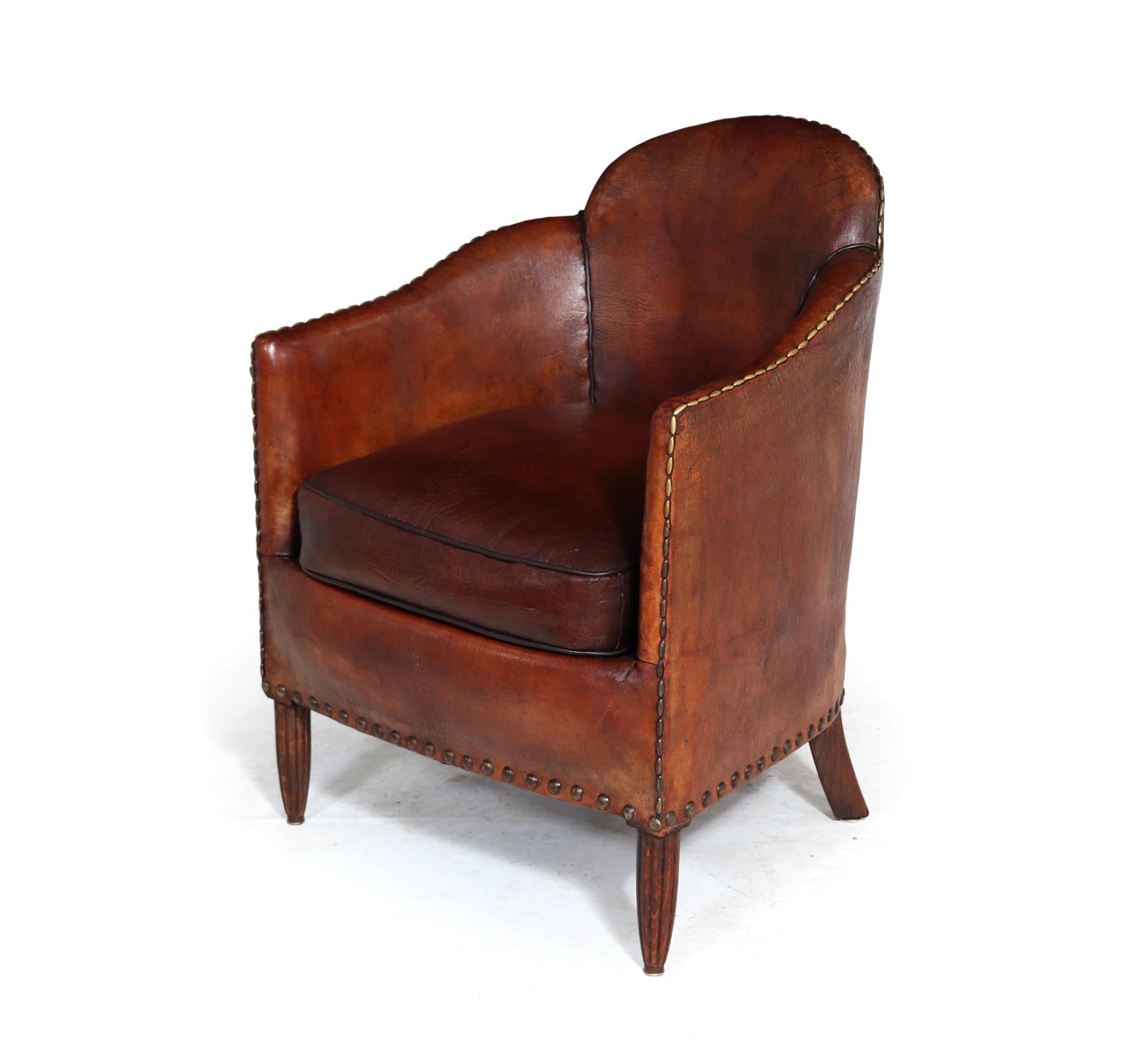 A very rare and stylish French Art Deco armchair having a shaped top and arms with reversible cushion with original fabric on lower side, the chair stands on turned reeded front legs and gently splayed legs to the back, the chair is very comfortable