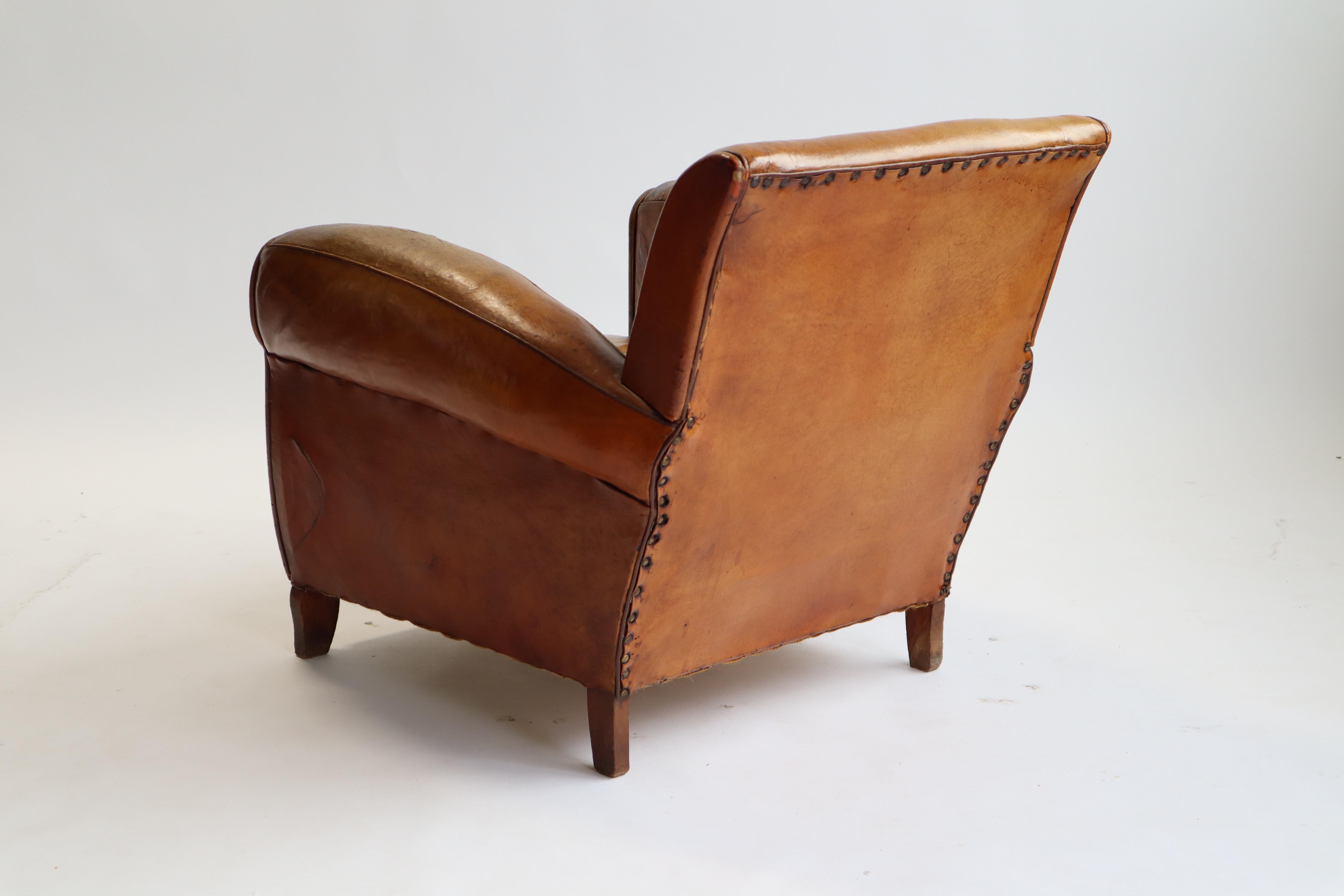 Art Deco club chair in original leather, France 1940s. Nice patina throughout.