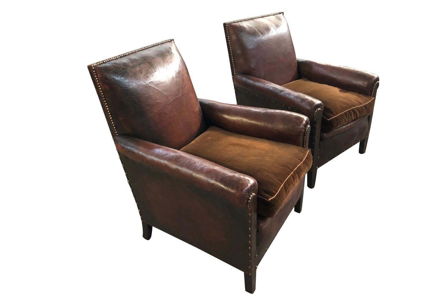 A fabulous pair of French Art Deco period club chairs in leather. Beautiful color and patina. Wonderful Minimalist lines.