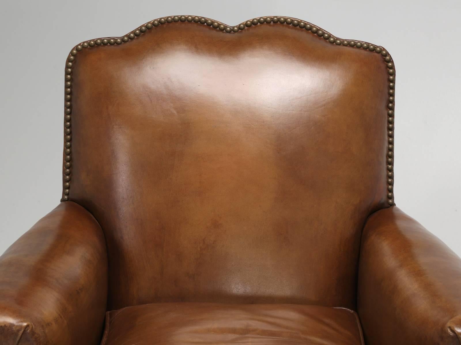 French Art Deco leather club chairs, that our Old Plank Upholstery shop, has completely and thoroughly restored, from the wooden frame up. Unfortunately, as hard as we tried, we could not save the leather on this pair of French Art Deco leather club