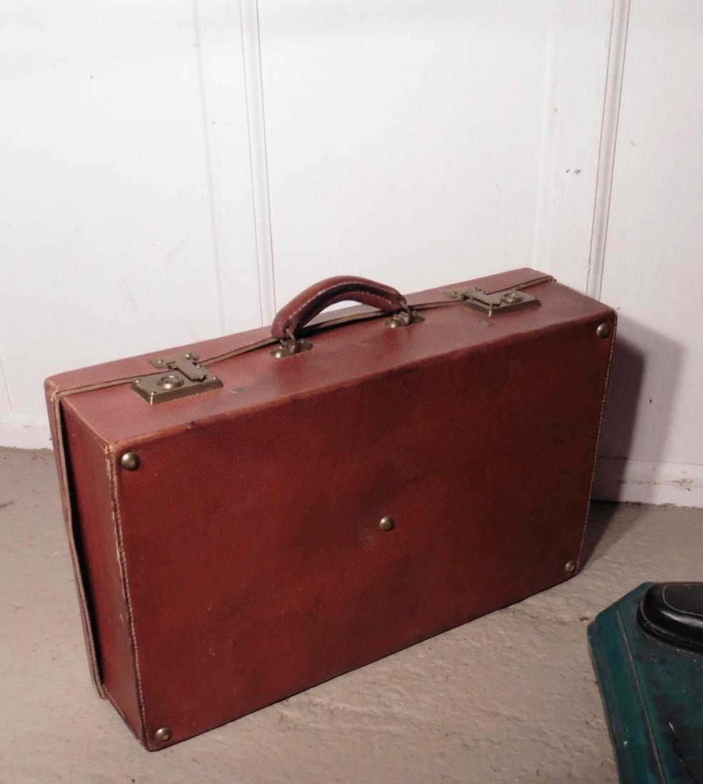French Art Deco leather suit case with original canvas cover

This is a good quality piece the tan hide is in good condition with no tears or bad stains, the locks all work well, the interior is clean it has leather straps and is lined in green