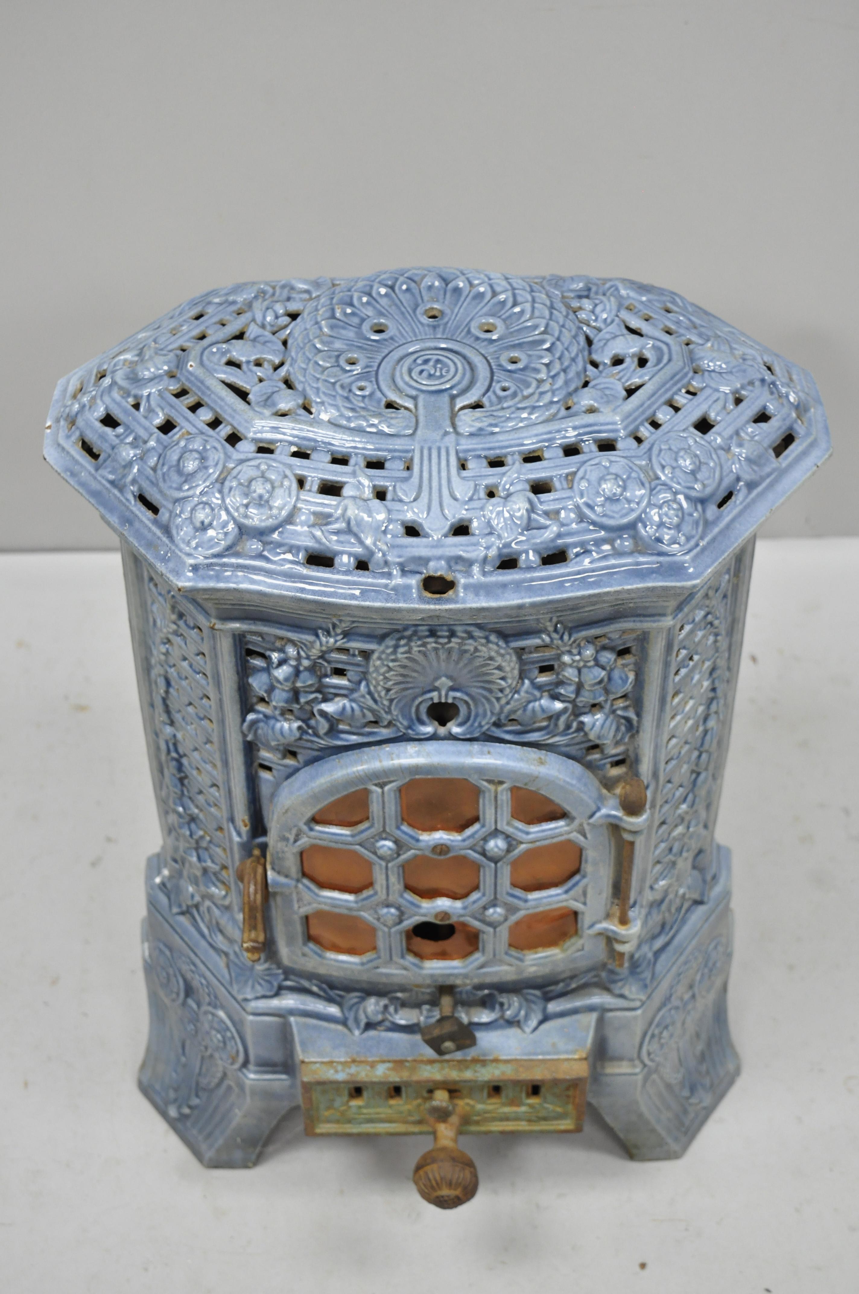 Antique French Art Deco lily cast iron blue porcelain heater tower stove by Deville Charleville. Item features heavy cast iron construction, blue porcelain enamel finish, unique smaller / midsize, signed 