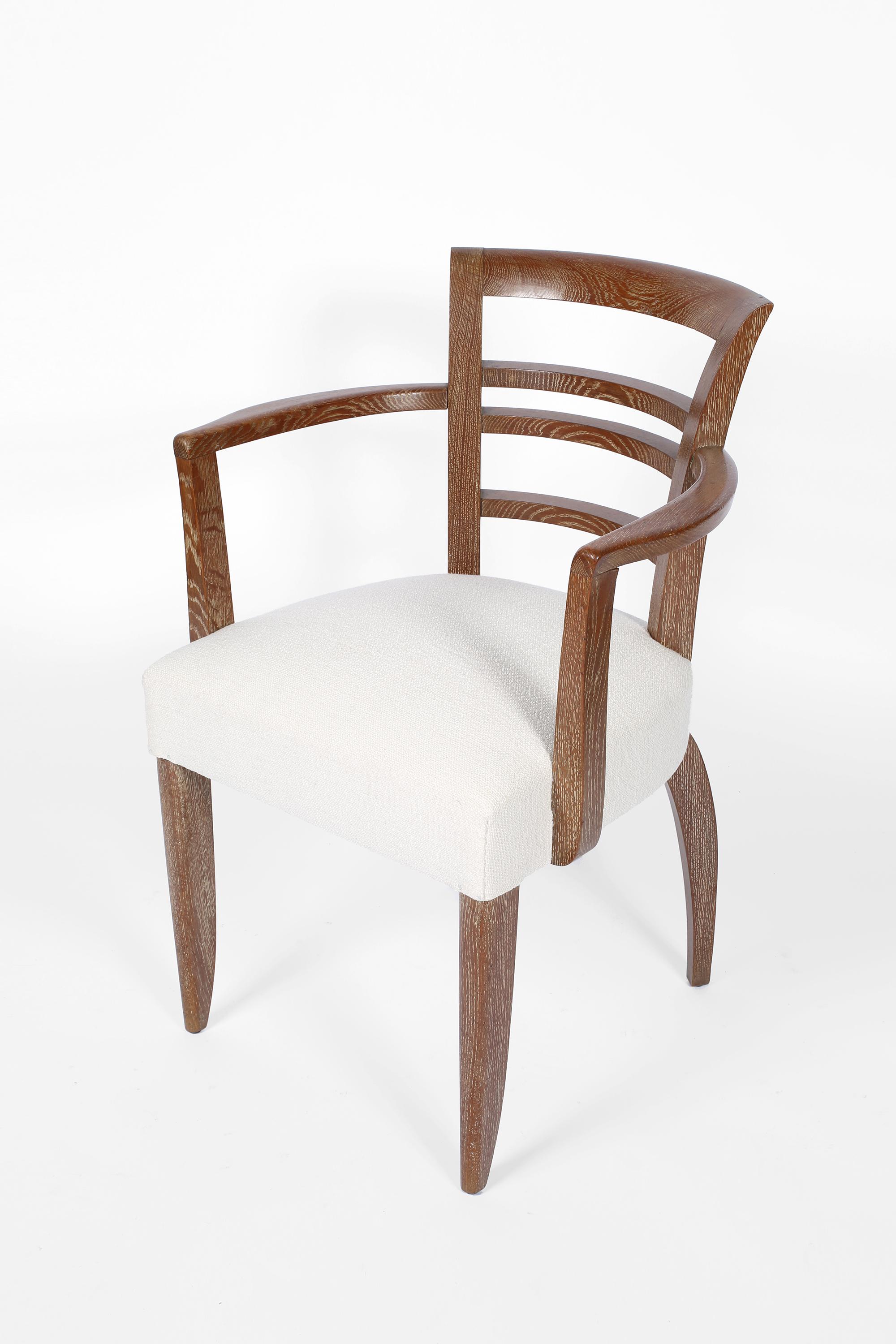 Art Deco occasional chairs with shapely limed oak frames and sprung seats, newly upholstered in textured white linen. French, circa 1940.

Measures: W57.5 x D56 x H81.5 cm 
Seat height 48cm
Arm height 67cm.