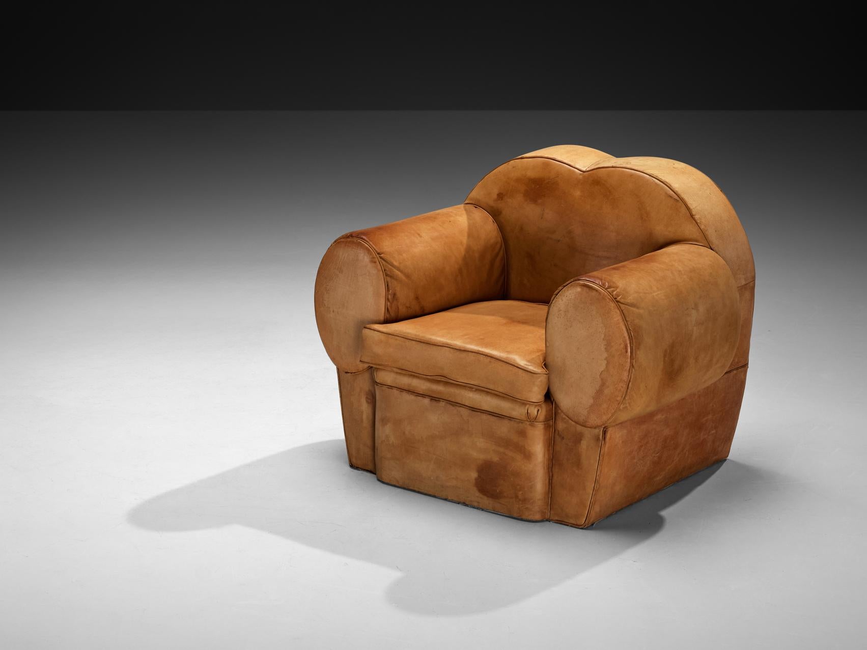 Lounge chair, leather, France, 1940s 

This lounge chair embodies the stylistic elegance of the Art Deco period, blending the refined aesthetic of the 1930s and 1940s. The frame features bold, curved lines and rounded edges, lending a sculptural and