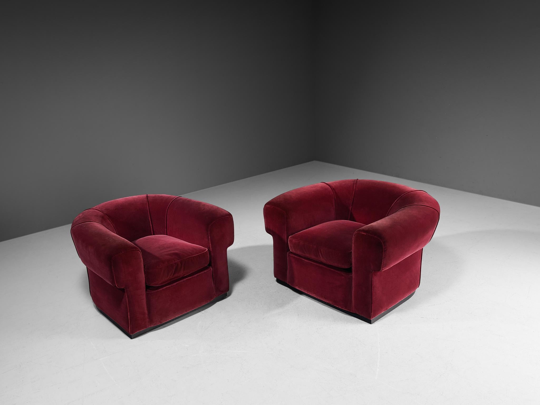 Pair of lounge chairs, velvet upholstery, lacquered wood, Italy, 1940s.
 
This exquisite pair of lounge chairs of Italian origin undoubtedly breathes the late Art Deco Period of the 1940s. The design has a certain theatrical aesthetic with curved