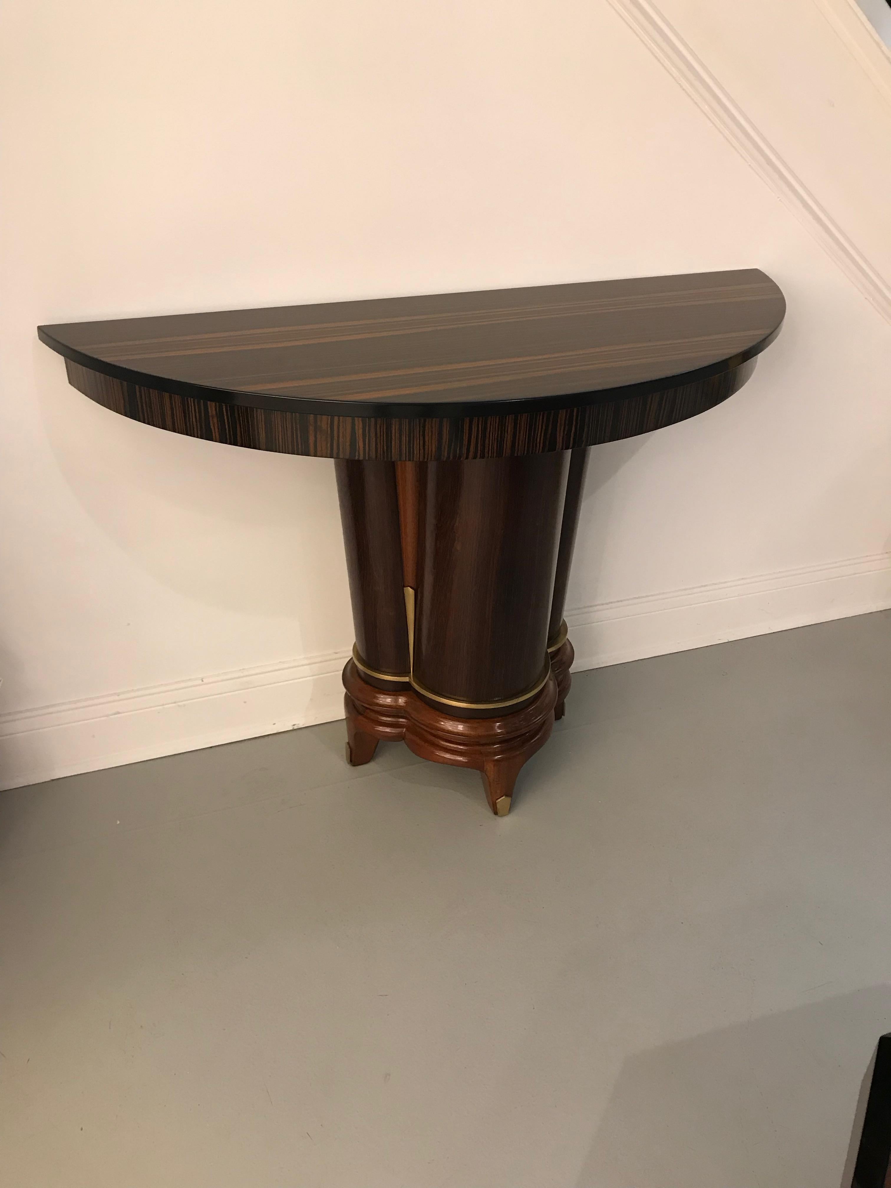 Beautiful French Art Deco Macassar console table. Half moon Macassar top sitting on gorgeous deco base with brass hardware.