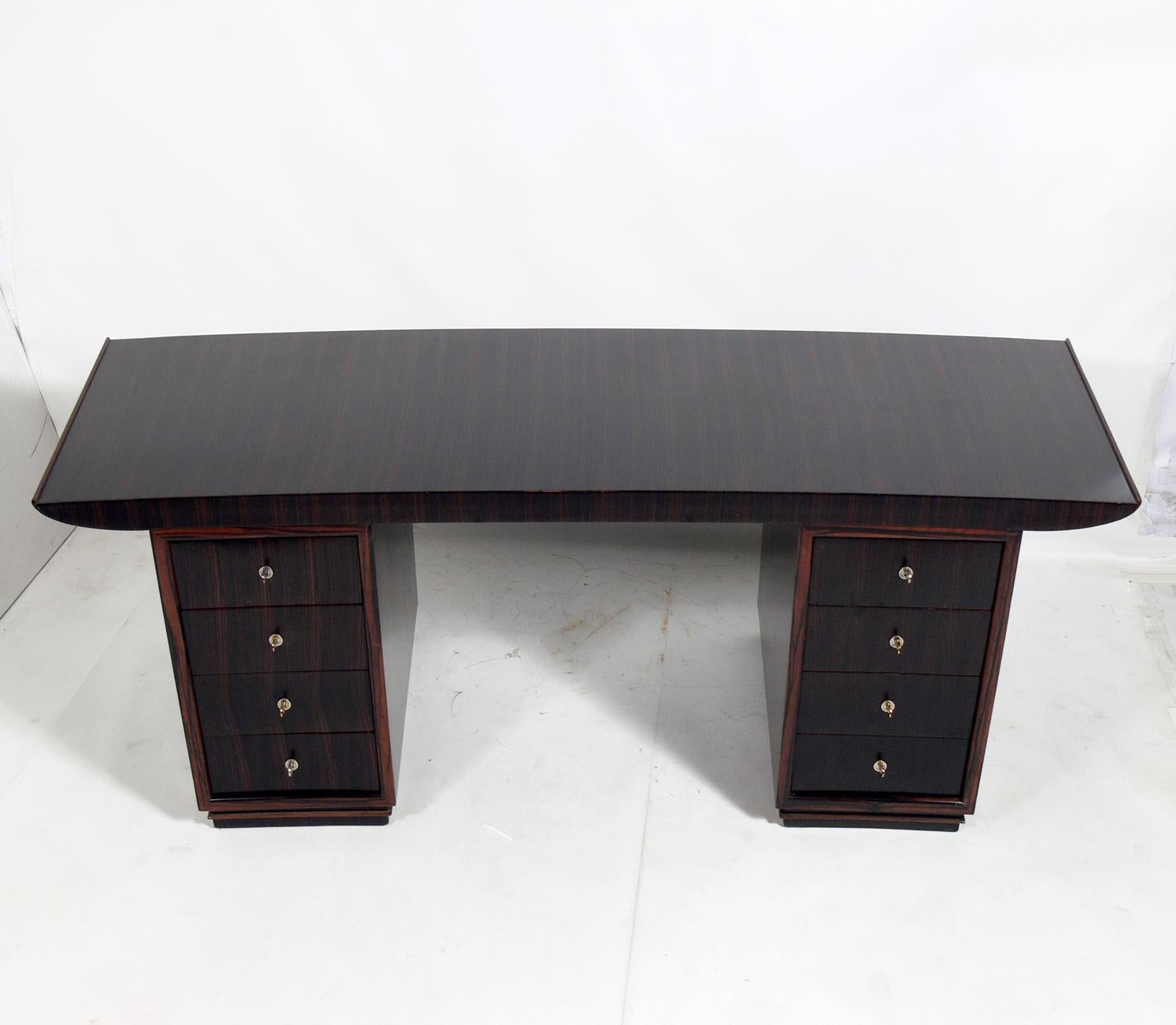 French Art Deco Macassar desk or bureau plat by Dominique, unsigned, France, circa late 1920s-1930s. Beautiful figured graining to the macassar ebony. Recently refinished and ready to use.