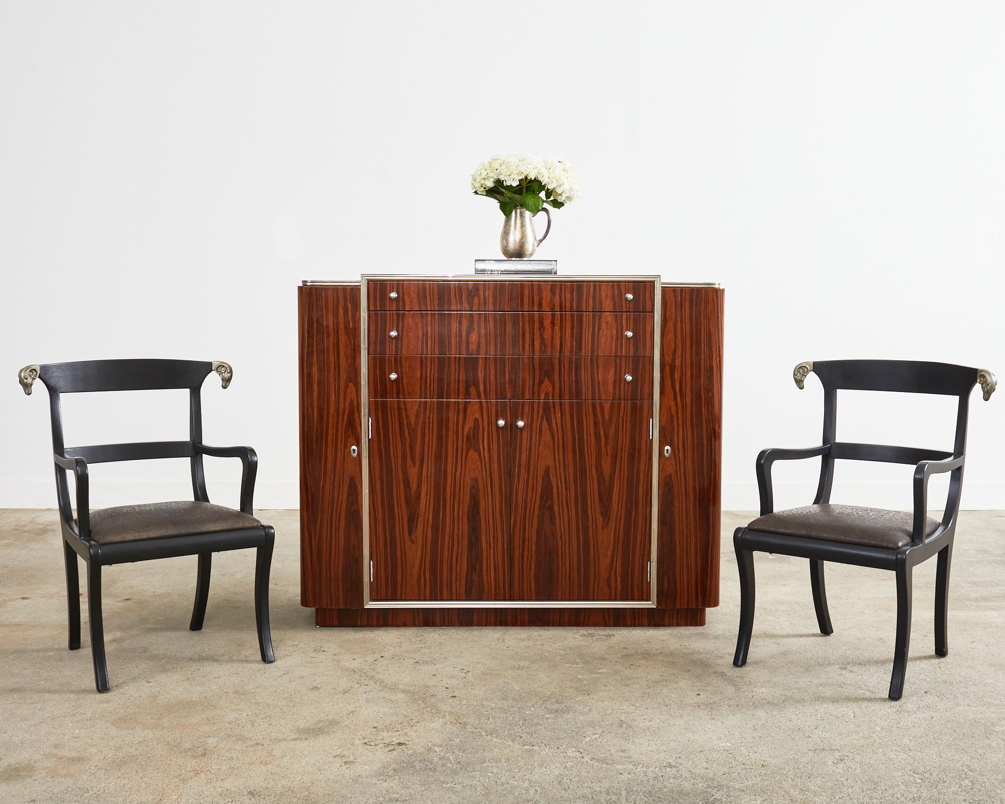 This opulent and rare french art deco dry bar cabinet was Ralph Lauren's inspiration for the modern Duke bar. The bar features a mahogany frame embellished with exotic book matched Macassar veneer. Each side of the large cabinet has doors to open to