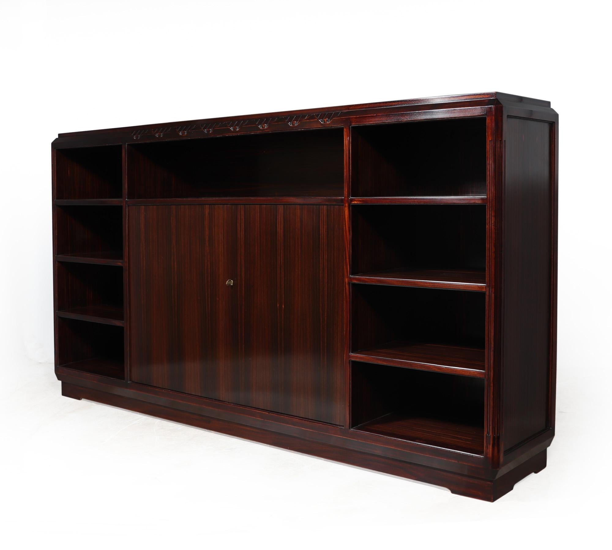 ART DECO BOOKCASE BY LOUIS MAJORELLE
A very large open library bookcase produced in Macassar Ebony with two lockable doors in the centre having the original key, the bookcase was designed and produced by Majorelle Nancy in the 1920’s in France it