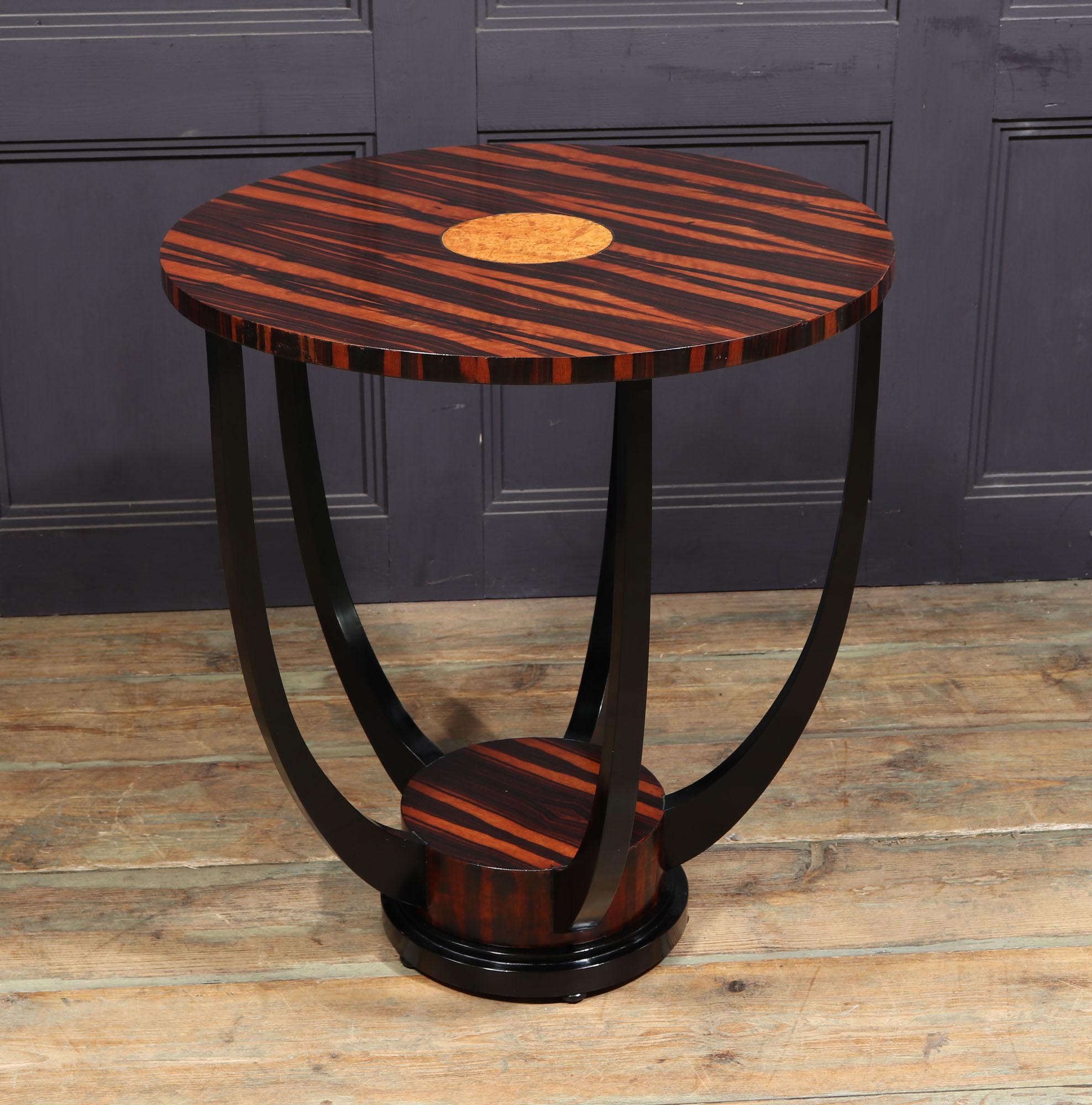 FRENCH ART DECO SIDE TABLE
A French Art Deco side table in Macassar ebony with amboyna inlayed centre with five shaped uprights supporting the top and an ebonies stepped base with four small bun feet The table has been restored and fully polished by