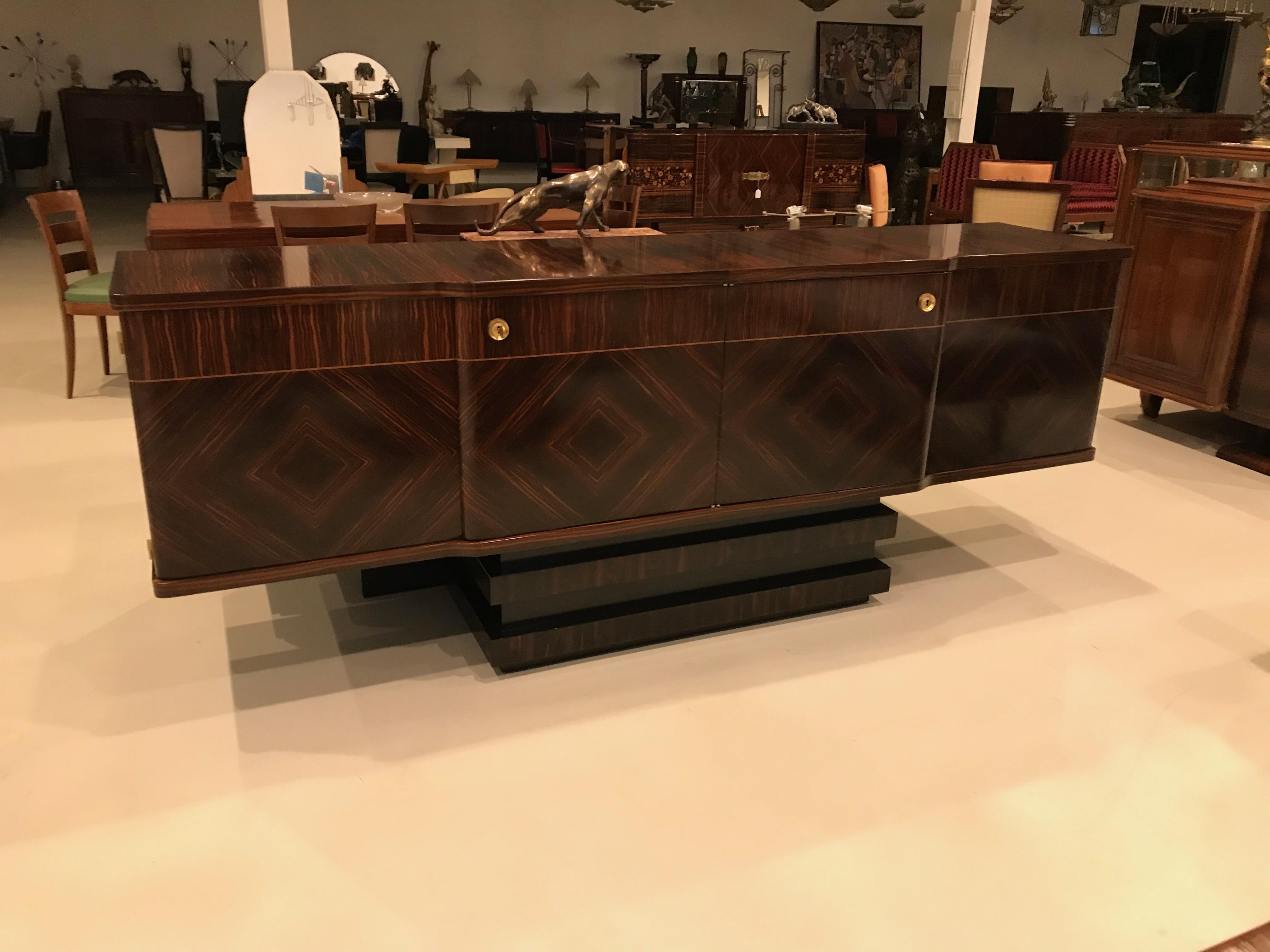 Stunning French Art Deco Macassar ebony sideboard or buffet with dry bar. Sitting on centre matching Macassar base the interior is lemon wood. Perfect credenza to add to your home for deco decor.