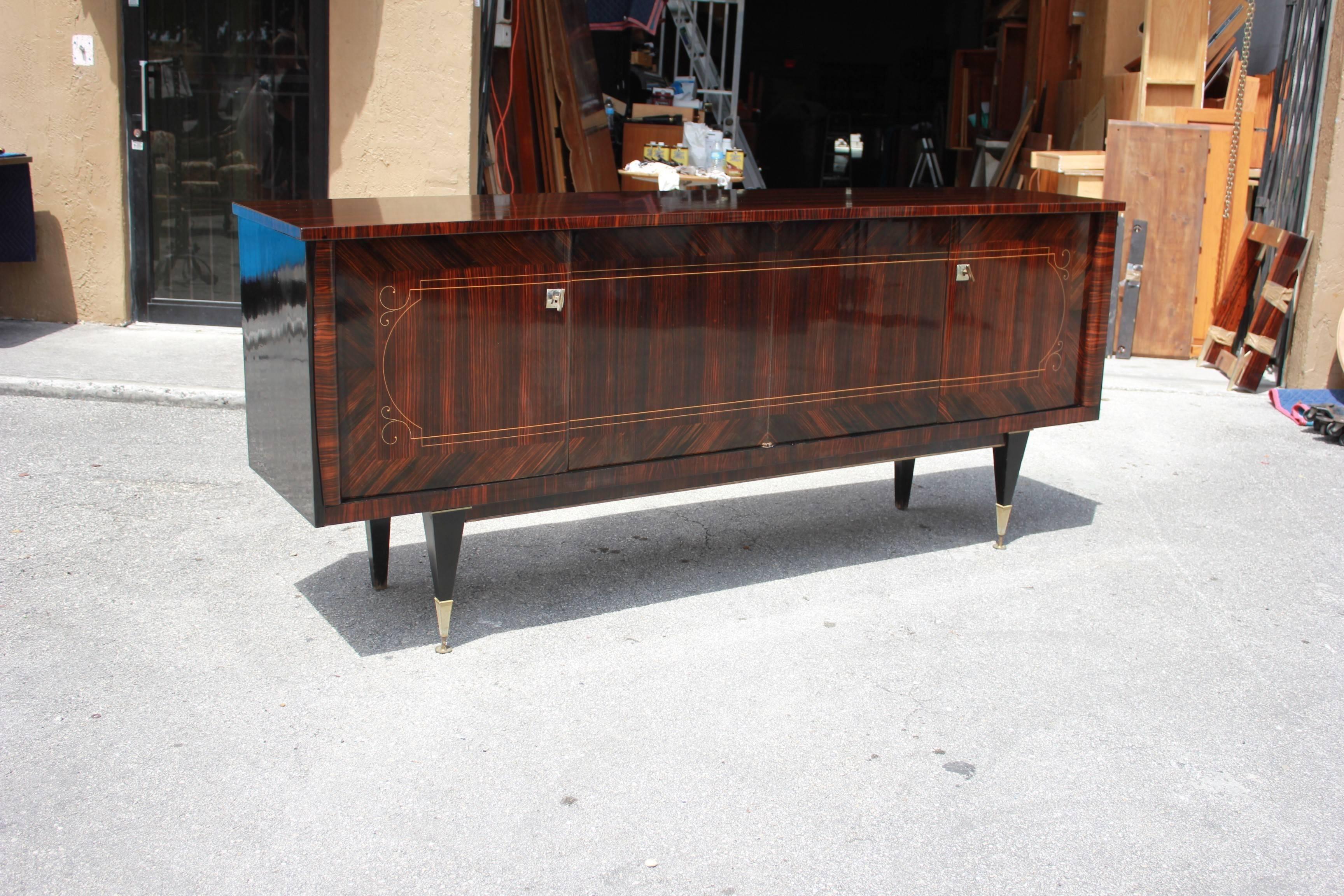 Beautiful French Art Deco exotic Macassar ebony dark grain sideboard or buffet with two drawers inside and all four shelves adjustable, you can remove the shelves if you need more place, beautiful bronze hardware detail, circa 1940s. Size 93.75