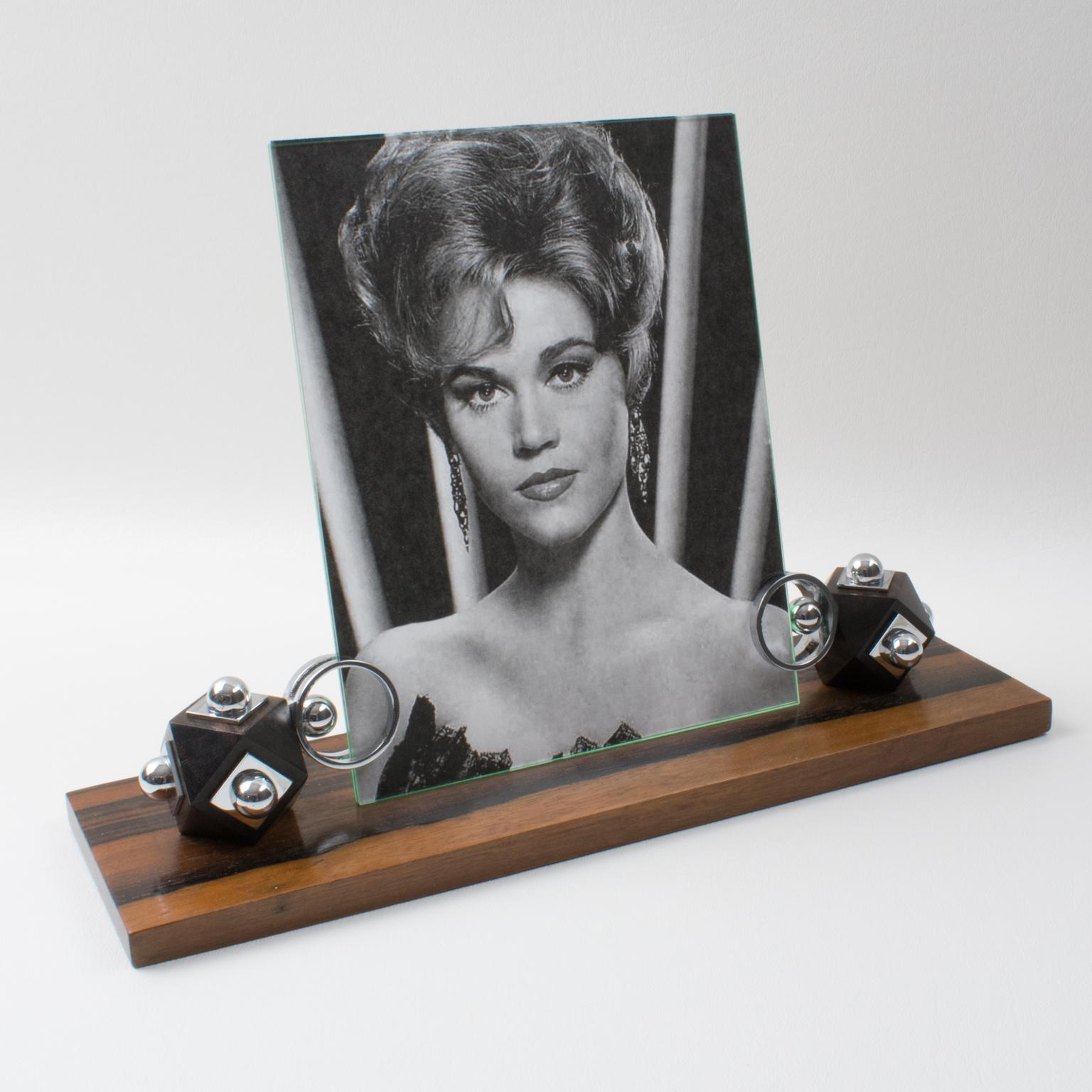 This Art Deco modernist picture photo frame features a thick hand-rubbed Macassar wood plinth complemented with cubic Macassar wood holders ornate with chrome accents. The piece is complete with two glass sheets to enclose the photography. There is