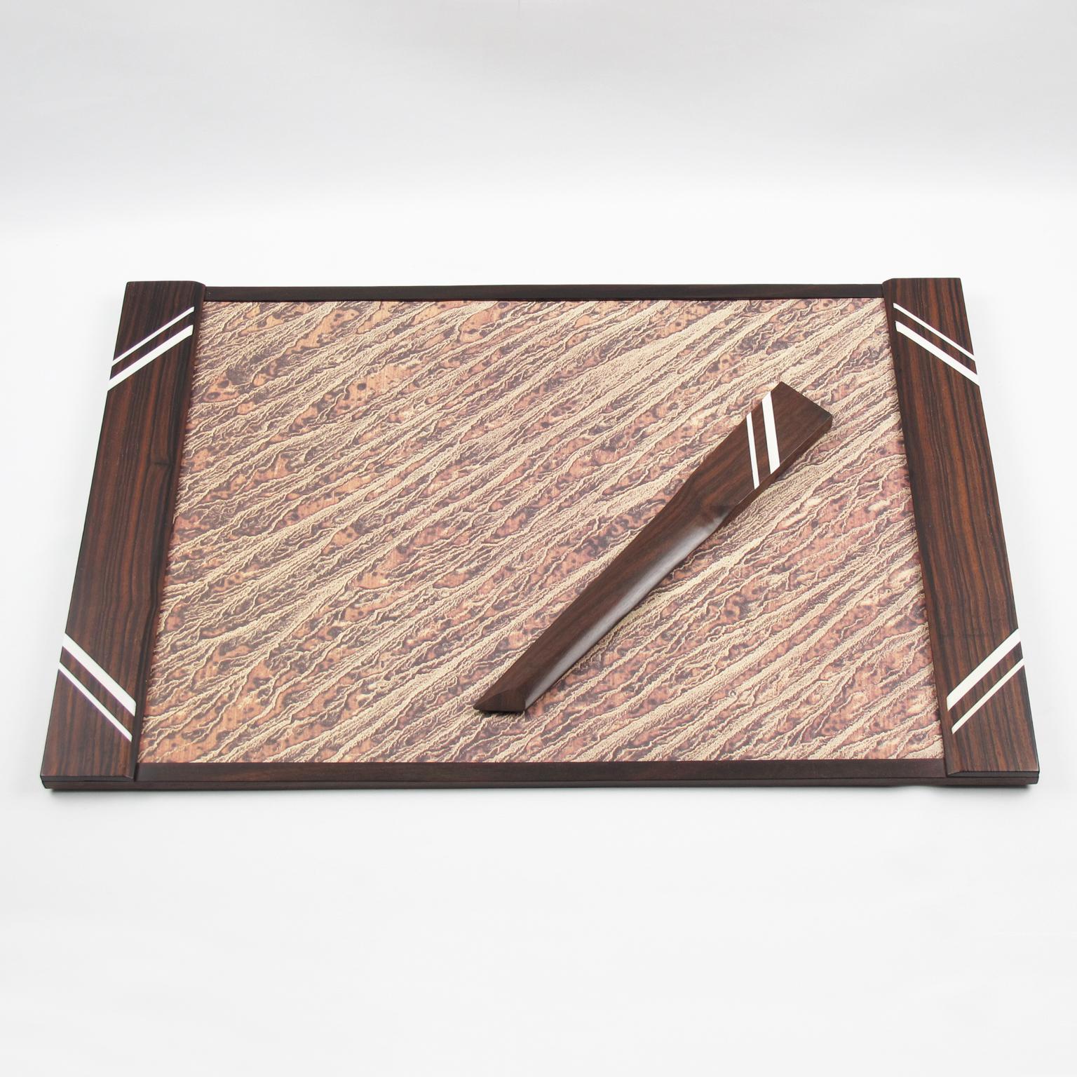 Stunning French Art Deco desk set, featuring a large blotter pad and letter opener in Macassar wood with white Galalith trimmed inlaid decor.
Measurements:
Blotter pad: 19.88 in. wide (50.5 cm) x 13.38 in. deep (34 cm)
Letter opener: 10.82 in.