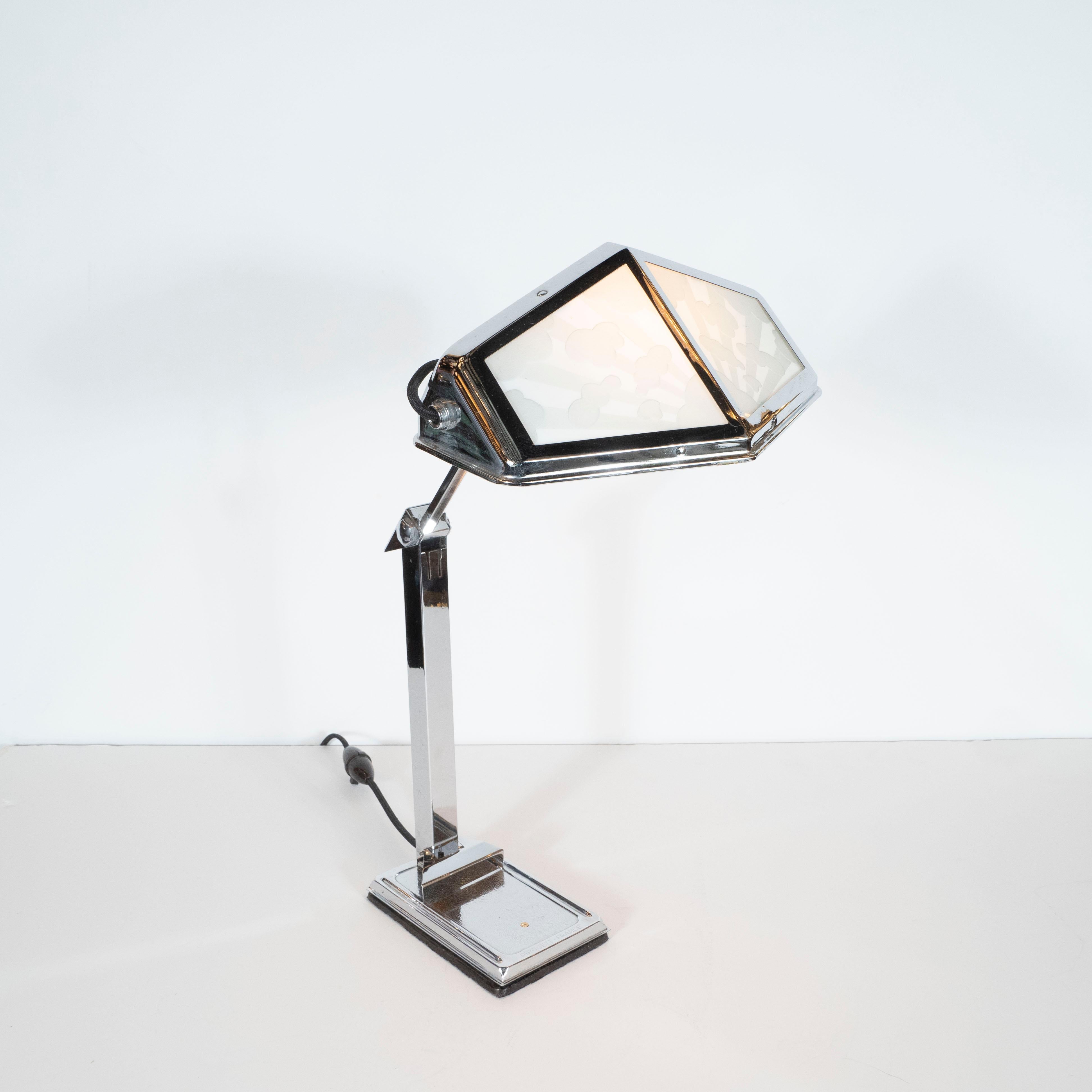 This stunning Art Deco Machine Age table lamp was realized in France, circa 1935. It features a shade 12 sided polygonal nickel frame that holds two pairs of glass shades in frosted glass (of two varying levels of opacity) on each side. Each
