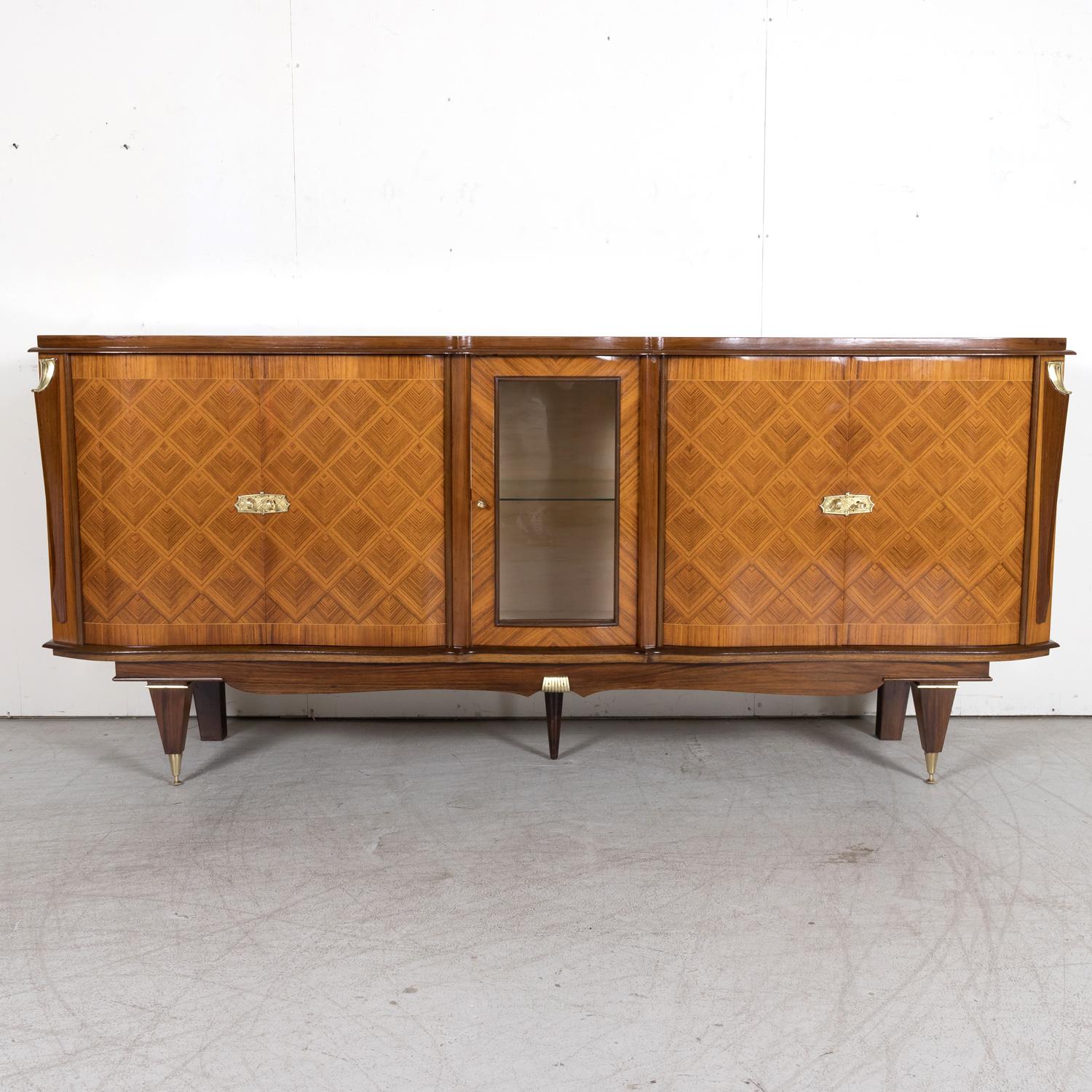 A stunning French Art Deco enfilade buffet or sideboard handcrafted of mahogany near Toulouse, the capital of France’s southern Occitanie region, with a stunning wood grain, rich patterned palisander parquetry, and bronze doré that accents the wood