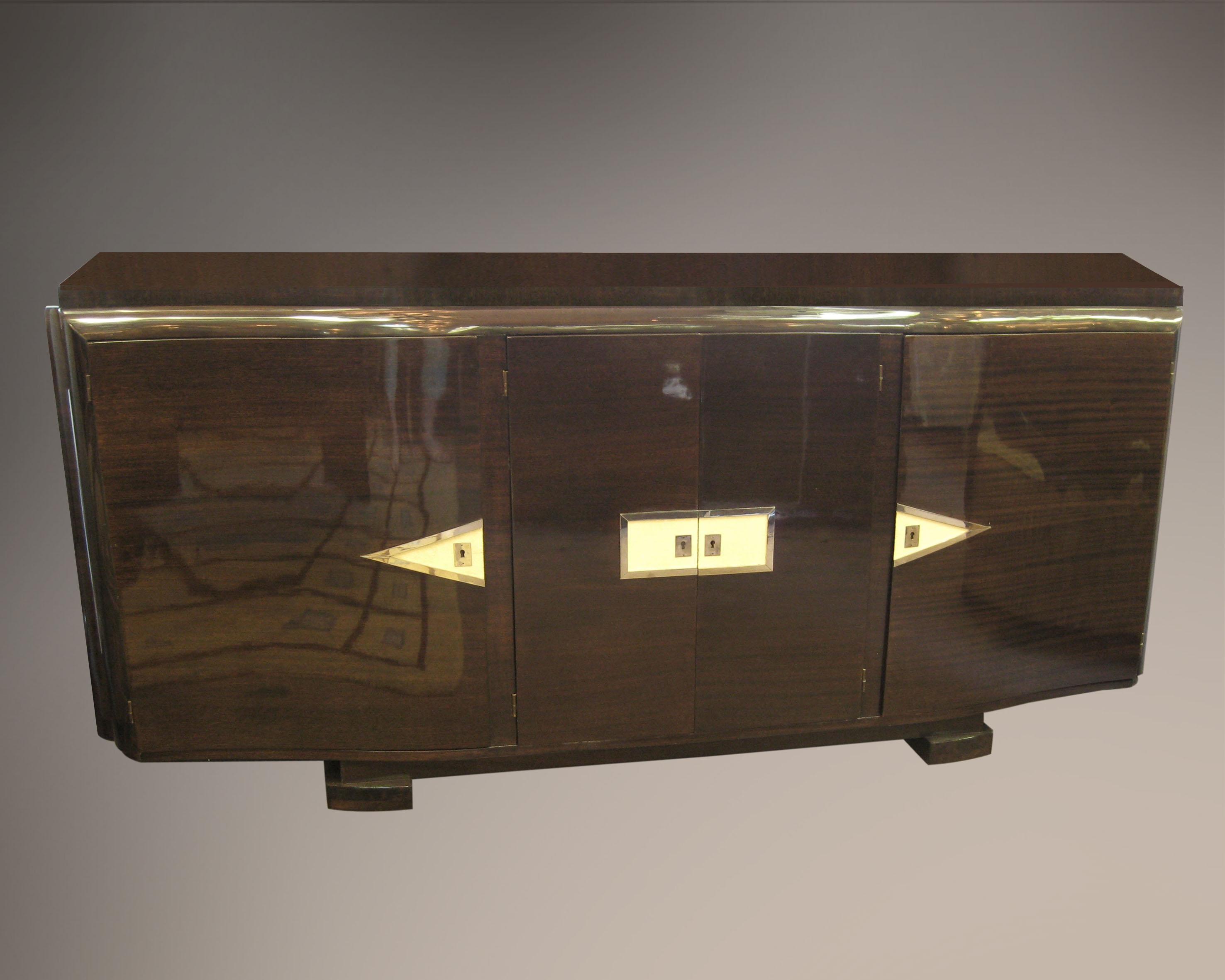 Modernist dramatic bow front credenza attributed to Andre Frechet, with a horizontal frieze of diamond and rectangular shapes inlaid in shagreen.
Thin nickel plated bronze framing delineates the rectangular sharkskin decorative detail on the