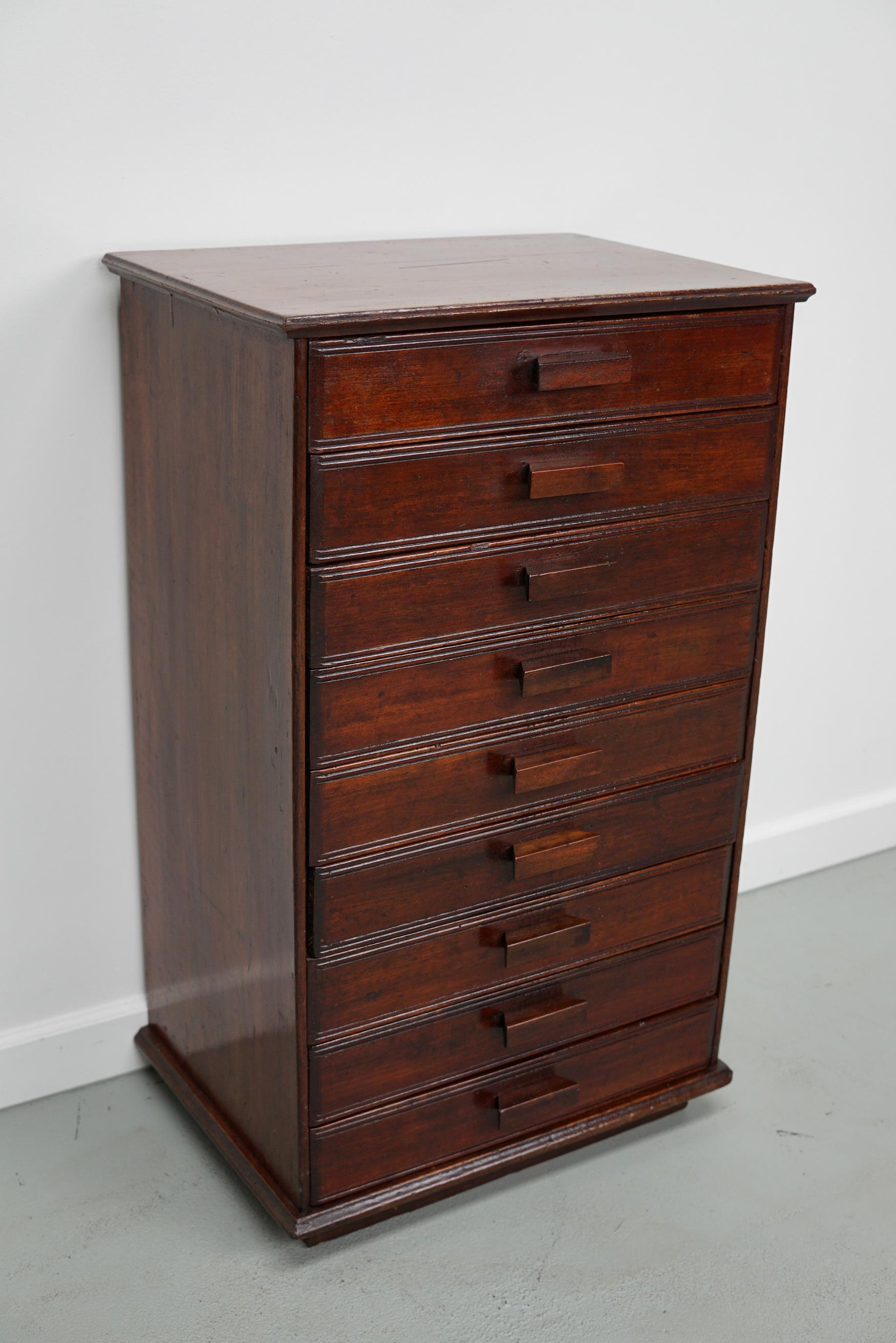 This cabinet was made around 1920 in France and features amazing Art Deco details. It was made from mahogany and features 9 drawers with mahogany handles and a non functional locking system.