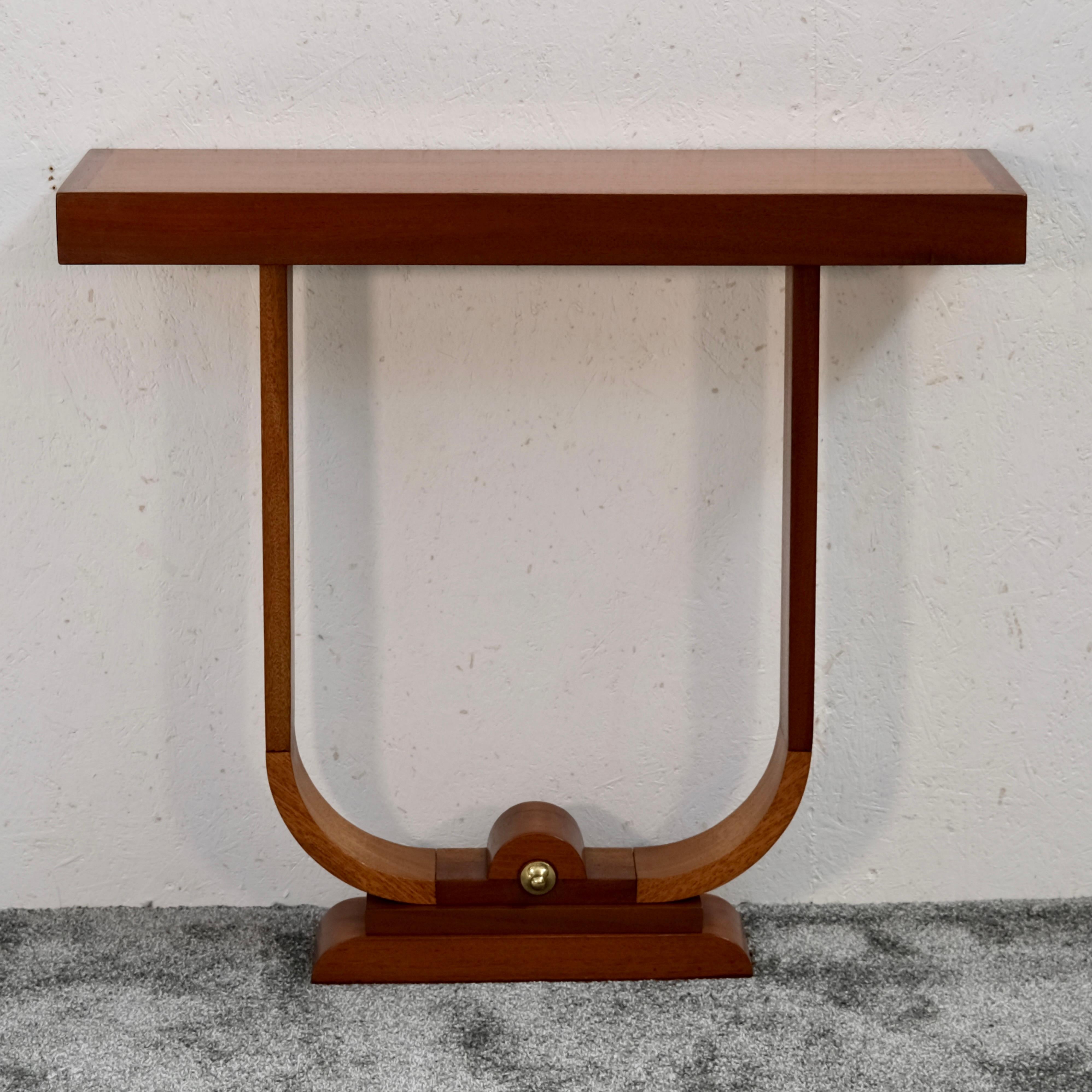 This French Art Deco console table – also known as a narrow side table, wall-mounted console or entryway table – dates to circa 1930 and is a fine example of refined geometric design in the style of the interwar period. Crafted from mahogany, it