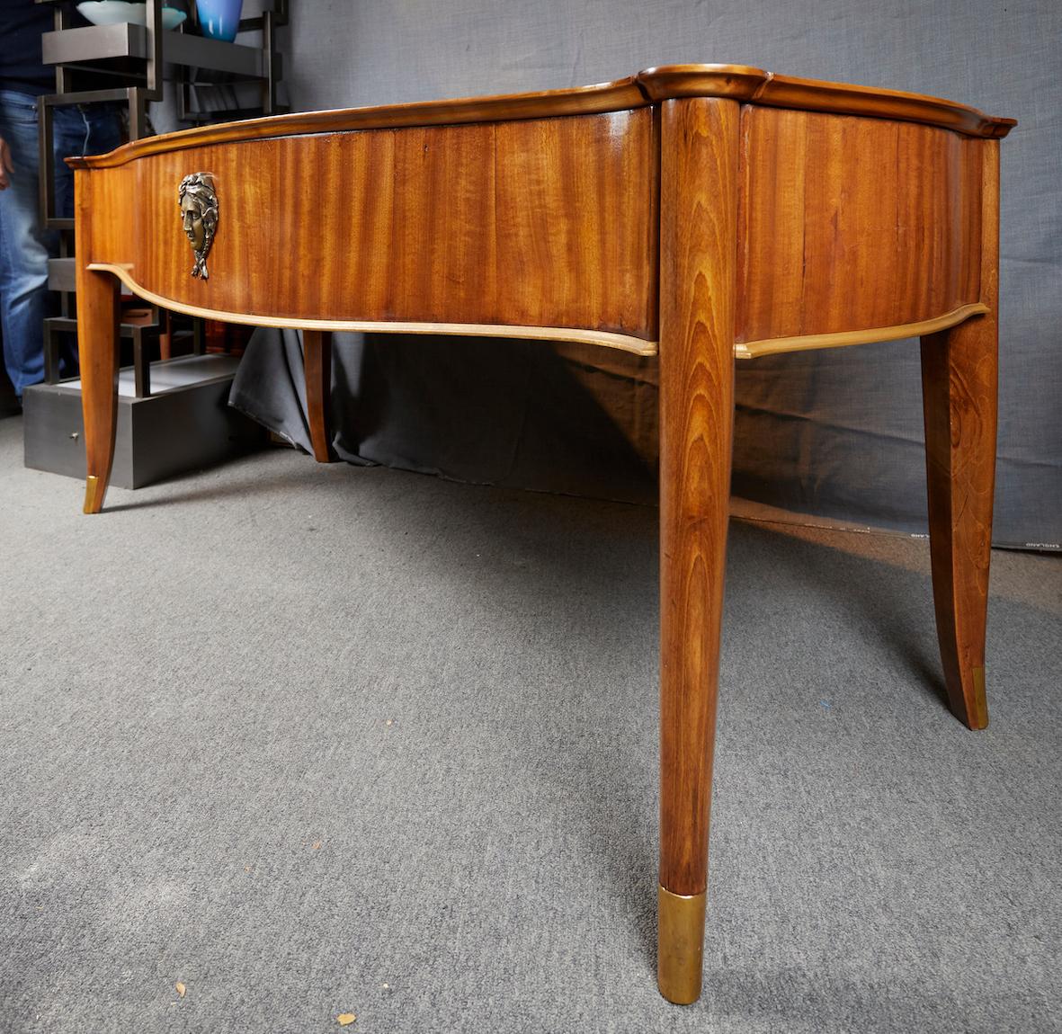 Art Deco Mahogany desk by André Arbus and Vadim Androussov decorated with a patinated bronze cartouche representing a female face France: circa 1940 Provenance: this secretary was part of a suite comissioned by Andre Arbus's personal physician.