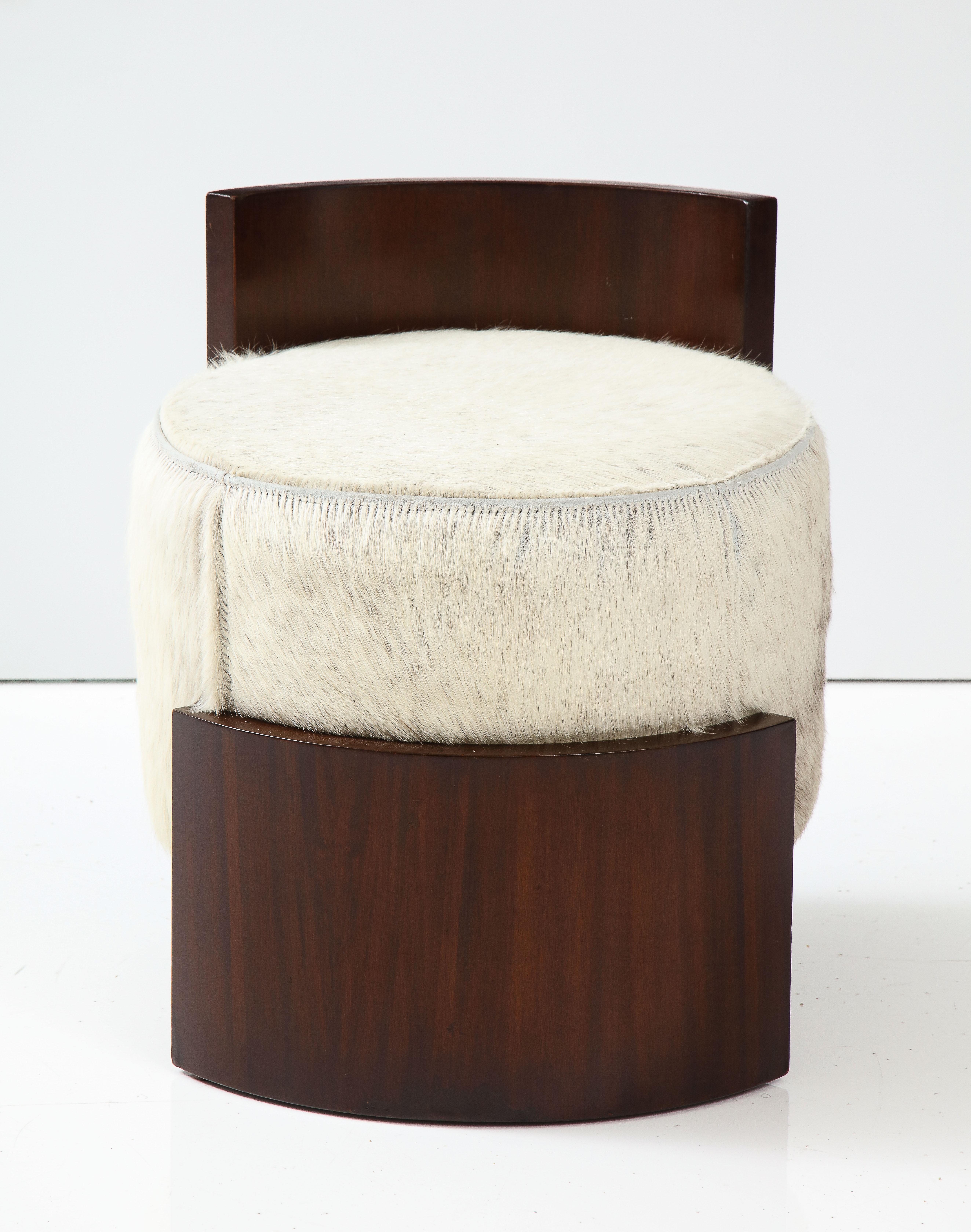 A glamorous French Art Deco mahogany stool with elegant backrest; with original goat skin upholstery.  A simple and streamlined design, with elegant curves which showcase the beauty of the wood.  The goat skin and high polished mahogany were highly