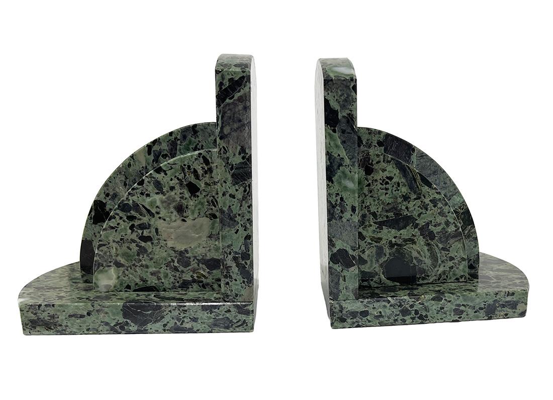 French Art Deco marble bookends, 1920

Green with black marble bookends, French, 1920. 
The marble has narrow faceted edges. 
Shows light signs of use
The measurements for each bookend  are 16 cm high, 14 cm wide and the depth is 10 cm
The total