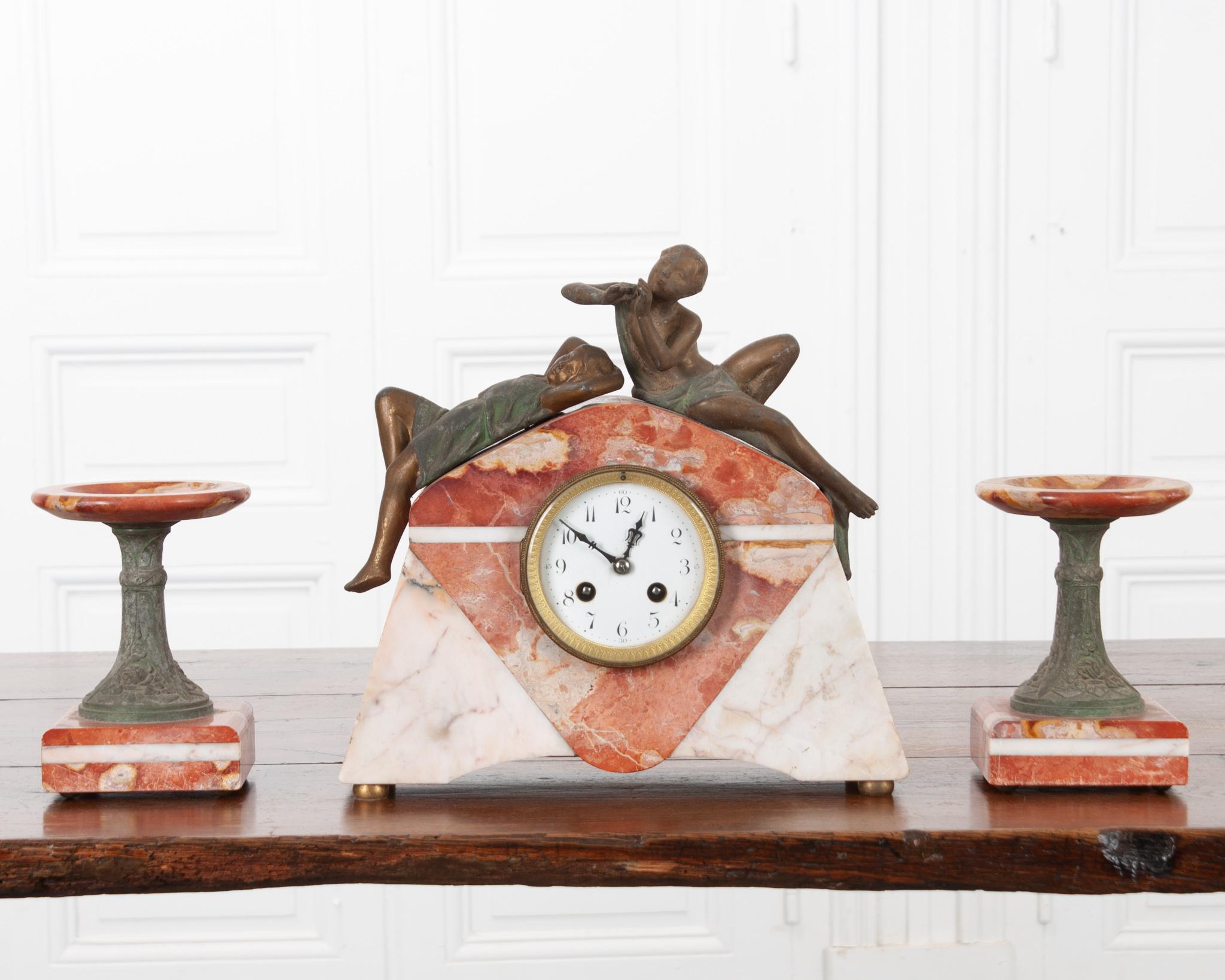 Beautiful and in working condition, this Art Deco mantle clock will add a touch of vintage whimsey to any living space. Created by Pierre Sega, a little known but prolific artist and sculptor in the early 20th century, signed on the male figure. The