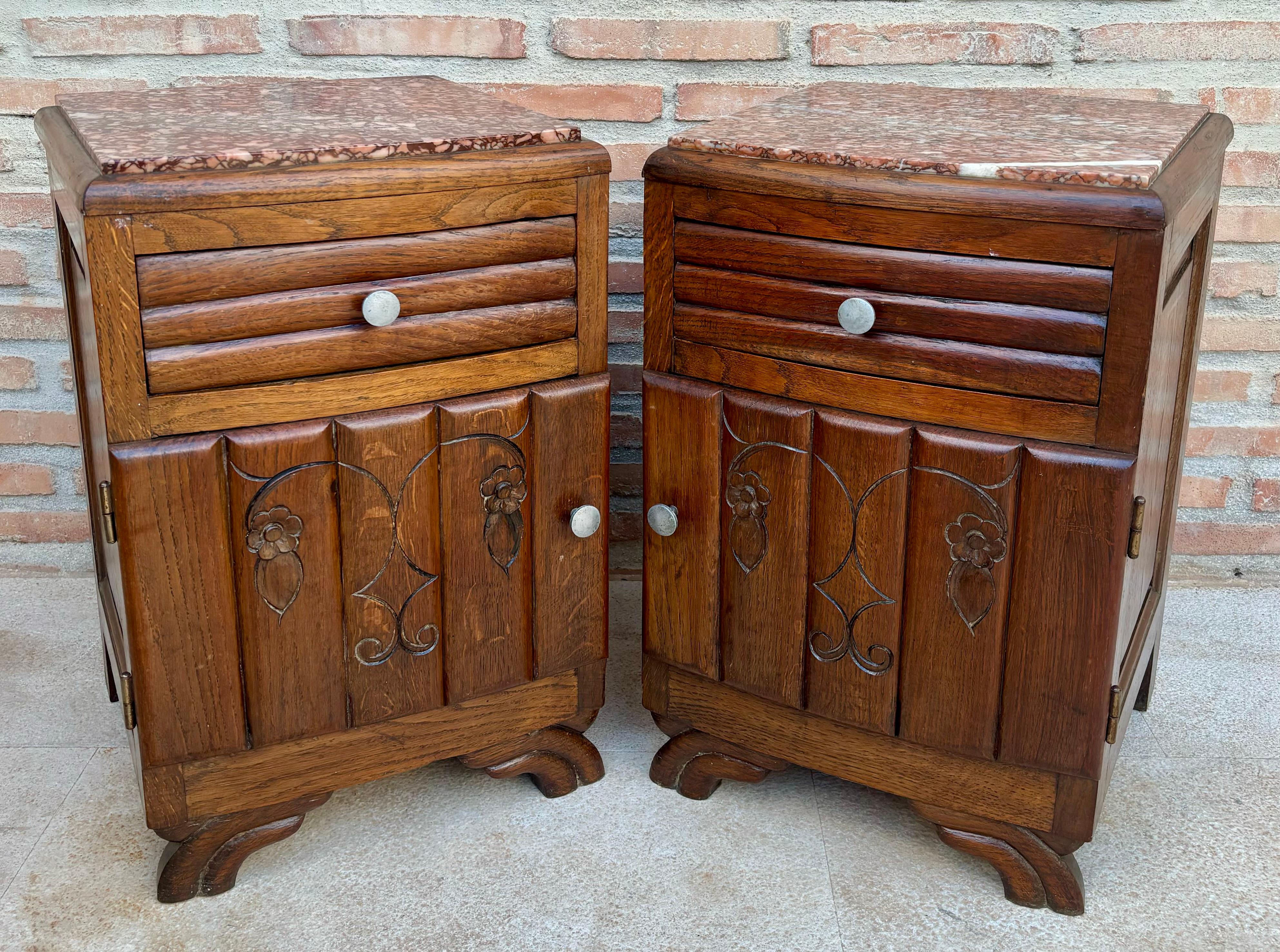 Pair of original Art Deco walnut nightstands. Originating in France and dating back to the early 1930s, they fill the highly desired form of Art Deco at its finest and resemble luscious carved walnut veneers. A wonderful design to delight the eye