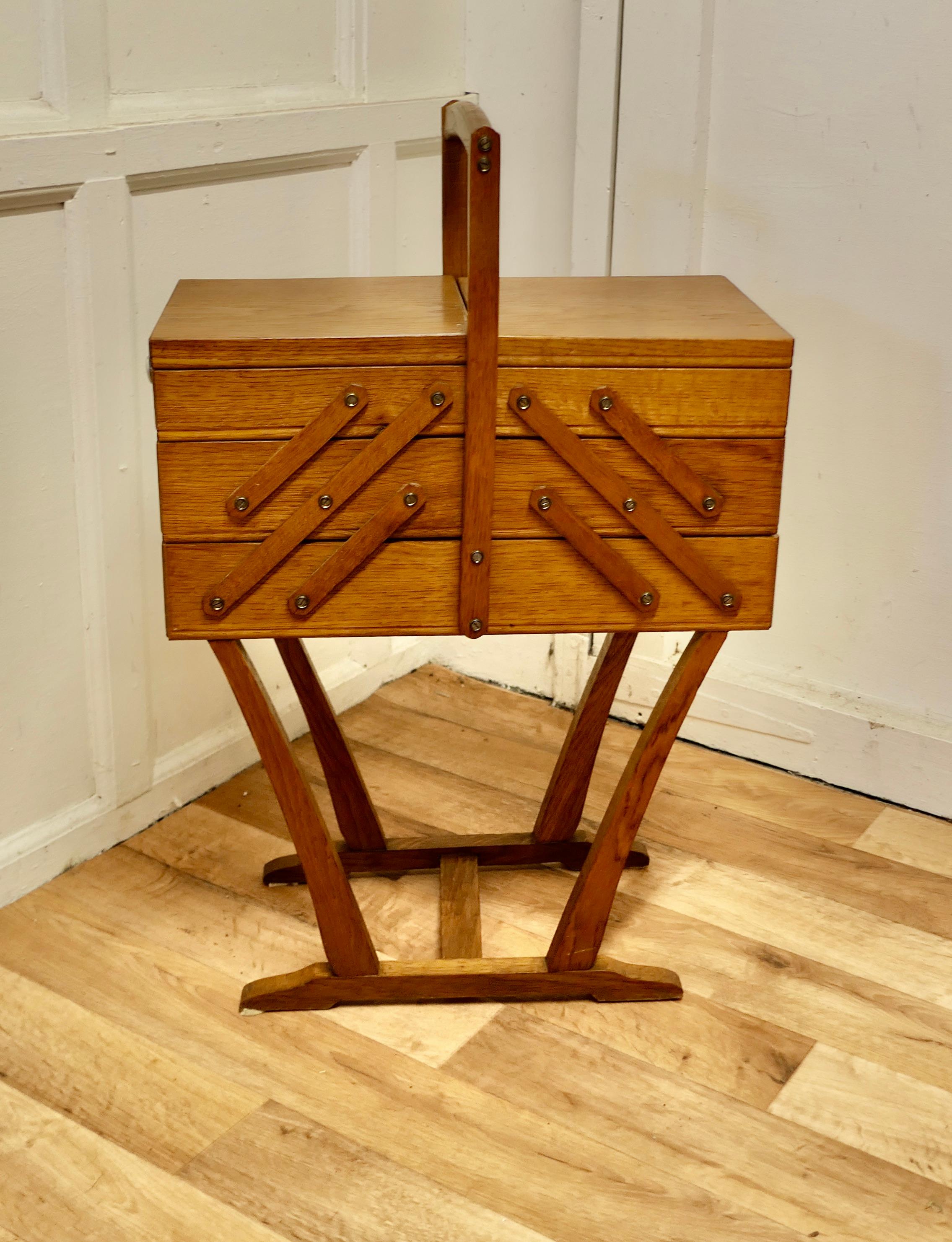 French Art Deco Metamorphic Concertina Sewing or Work Box 

Made in Golden Oak and very stylish 
So much storage in such a small space, this great little piece opens out to 4 times its size and then closes back up to a neat floor-standing carrying