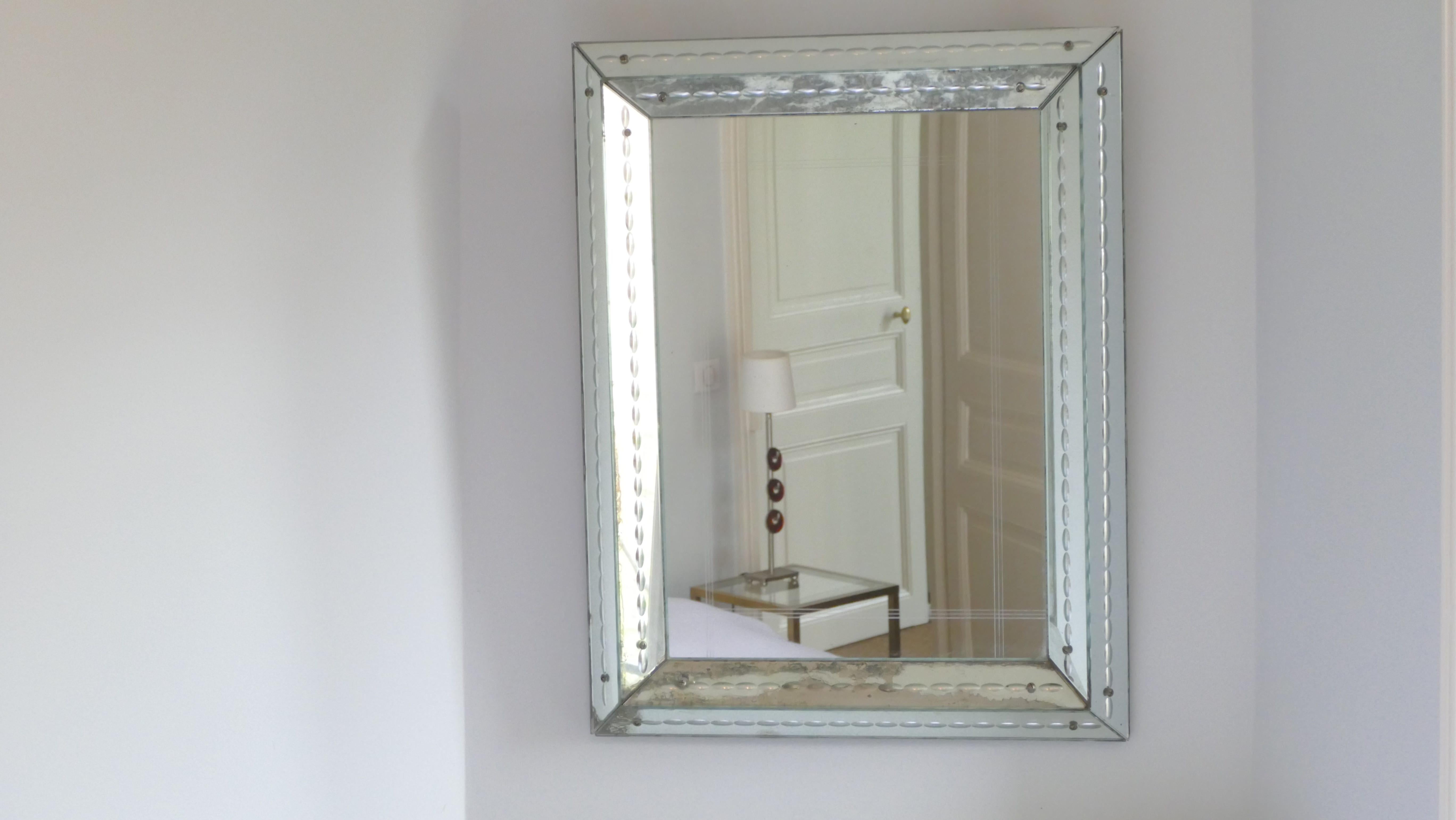 This weighty mirror attributed to Jacques adnet, from the 1940s, has aged gracefully; its charming patina now imbues it with a lovely romantic feel. Displaying elements of the late art deco period and early modernism, the mirror is typical Jacques
