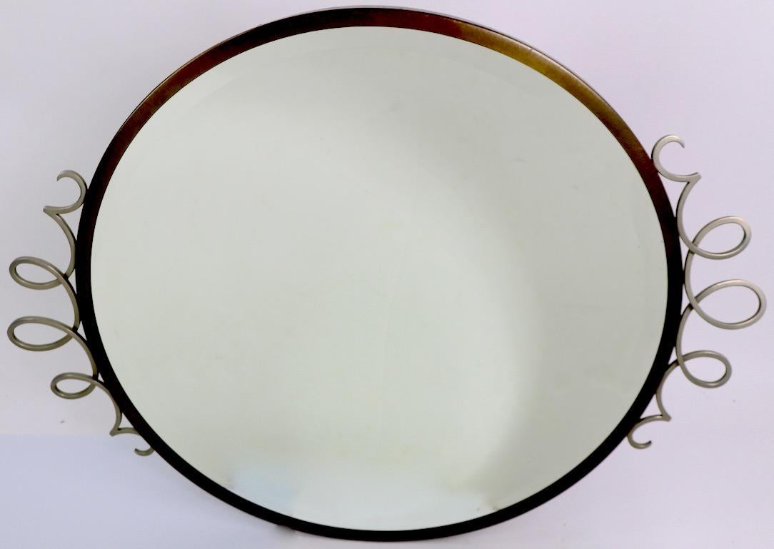 French Art Deco mirror, bevelled glass, with brass and decorative twist aluminum frame. Clean, original, ready to hang condition. Stylish and sophisticated design, period Art Deco item. Diameter of mirror without frame 26 in.