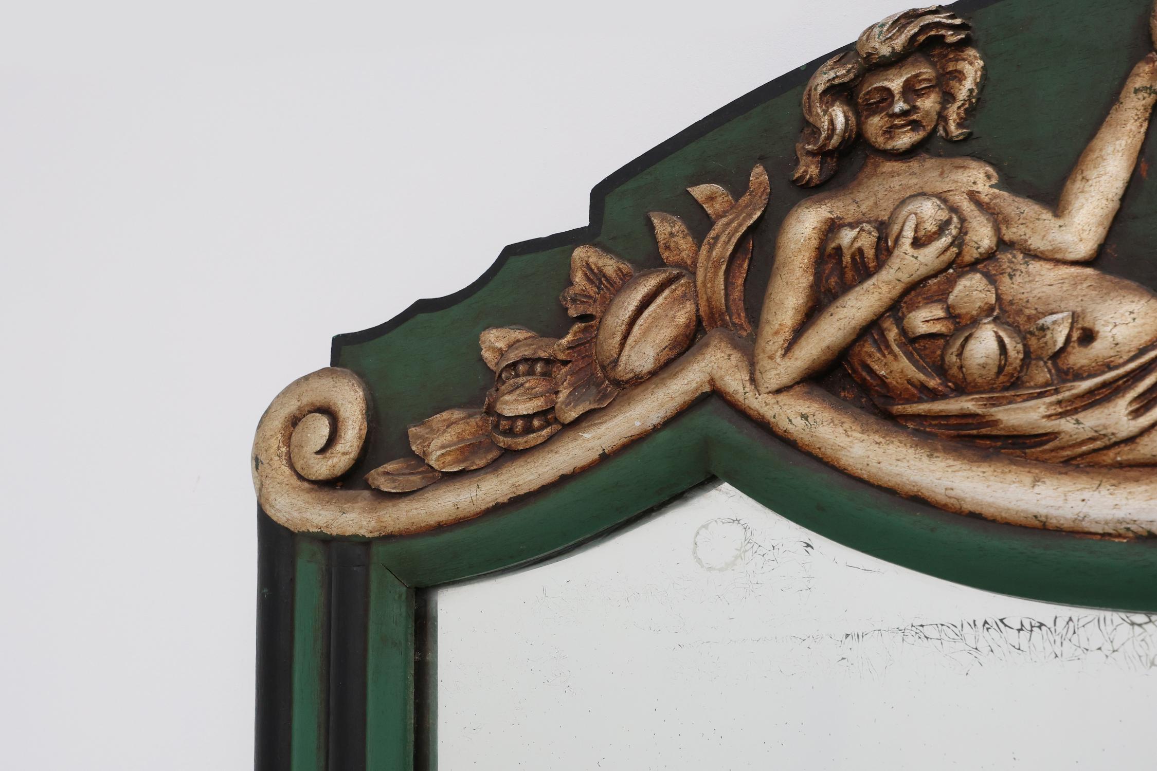 France / 1930 / mirror / wood / Art Deco

Rare French Art Deco mirror featuring a carved wooden frame in weathered green with patinated silver colored carved relief of an elegant naked woman eating grapes. The frame is holding 4 mirror plates with a