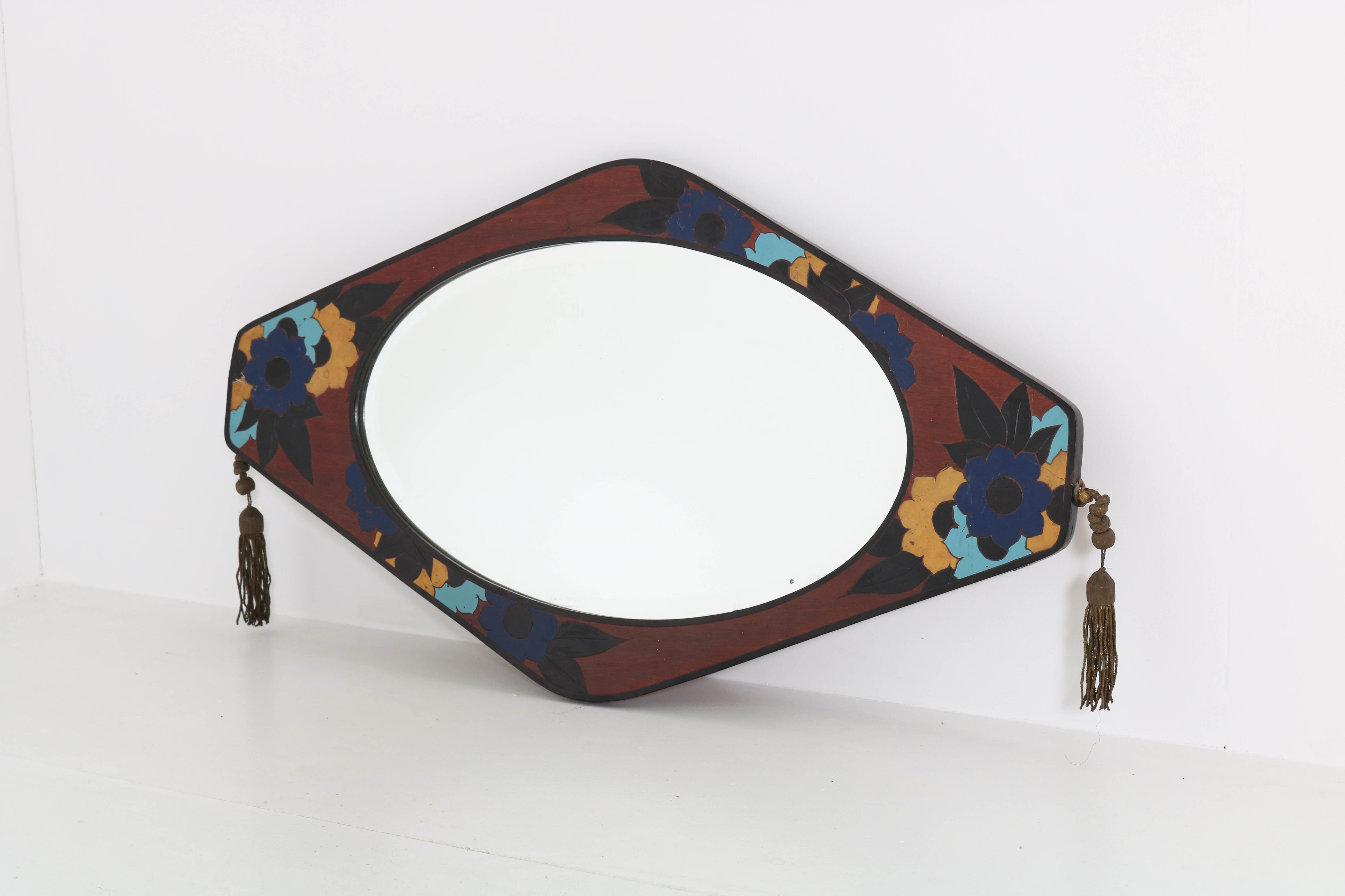 Wonderful and rare Art Deco mirror.
Striking French design from the thirties.
Mahogany veneered frame with original beveled glass mirror.
Original marquetry inlay of colorful flowers.
In good original condition with minor wear consistent with