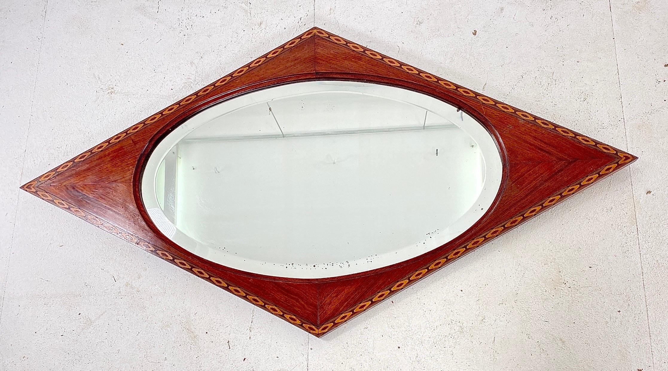 Wonderful and rare Art Deco mirror.
Striking French design from the thirties.
Mahogany veneered frame with original beveled glass mirror.
Original marquetry inlay.
In good original condition with minor wear consistent with age and