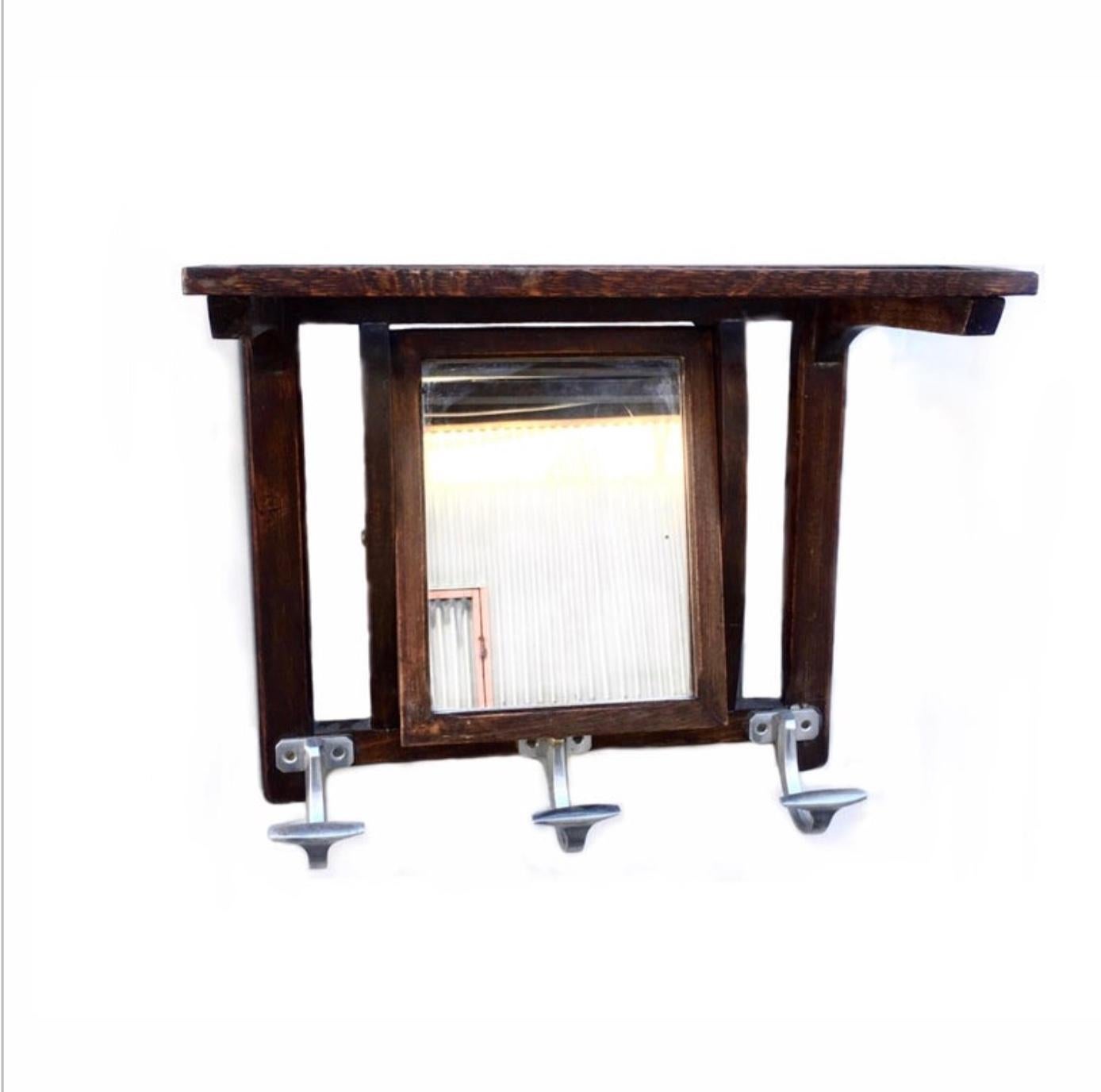 French Art Deco mirrored coat rack. Orientable mirror with 3 metal coat hangers and top slatted shelf.