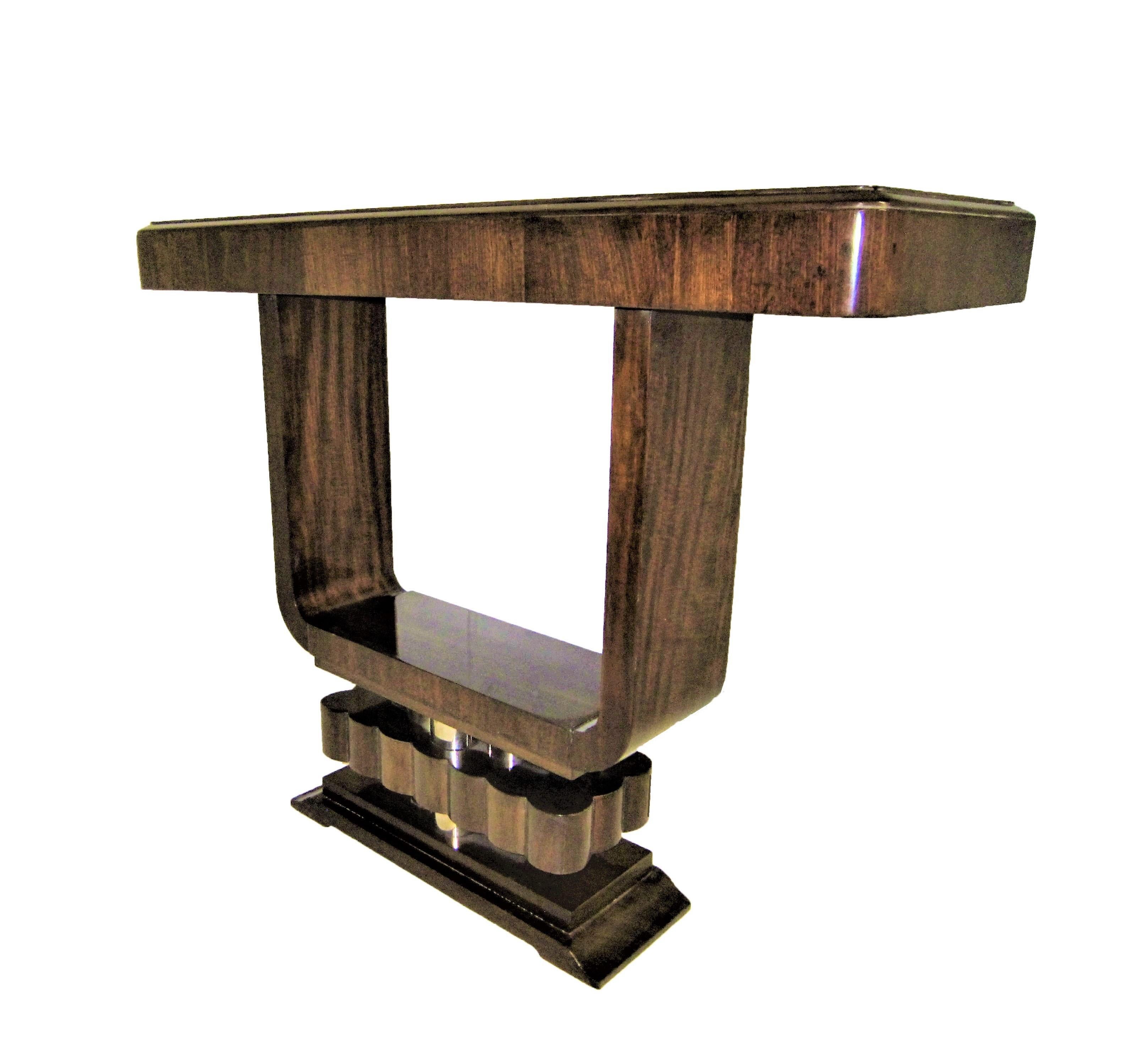 A fabulous original French Modern petite console of open cube form, raised on stepped and fluted pediment base. The negative area created in the center serves as a viewfinder which focuses our sight on the clean lines and simplicity of the form thus