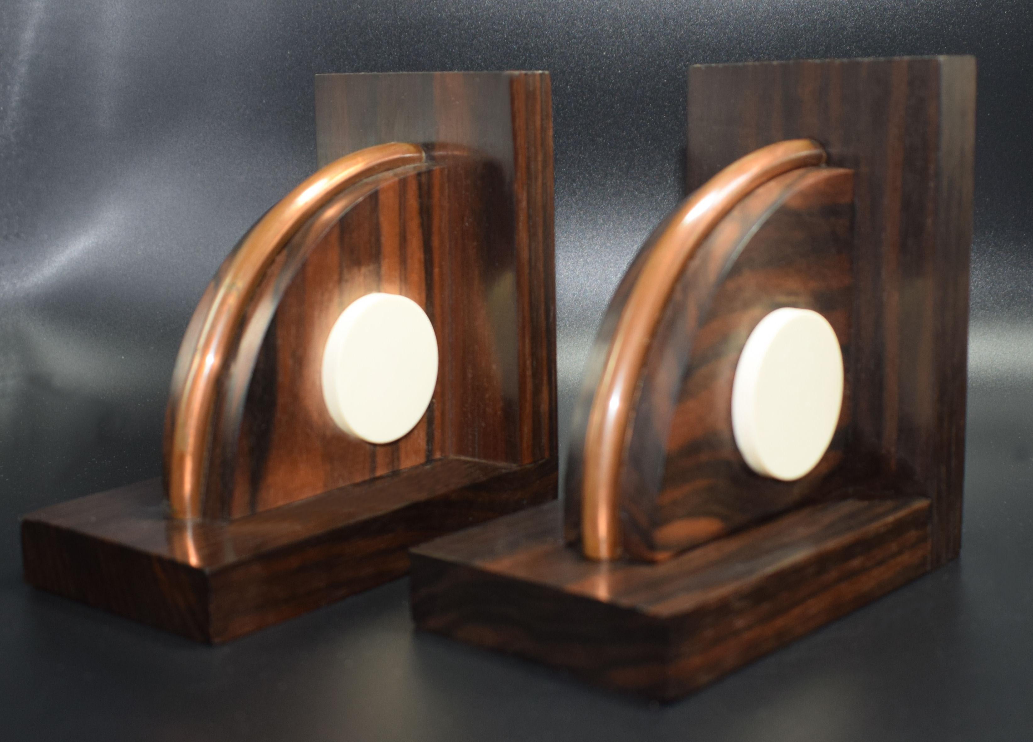 Fabulous matching pair of modernist 1930s bookends originates from France and made from Macassar ebony with Bakelite and copper accents. Condition is very good. Stamped 'Made in France' and retaining original labels.