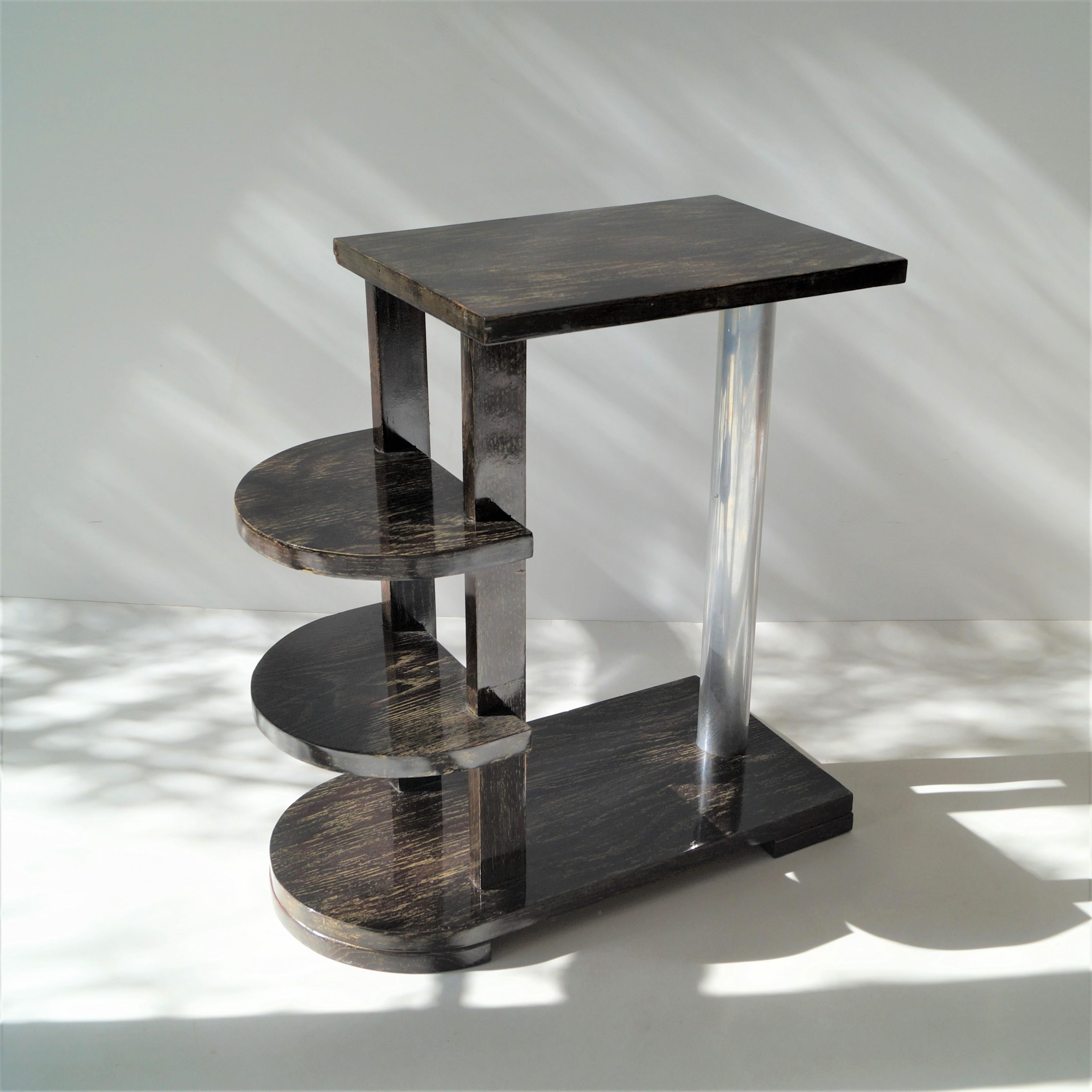 A rare 1930s modernist sidetable or serving table by Michel Dufet, in wenge veneer (bois palmier) with a polished nickel tube support and two half round shelves. A very similar table is documented in the following book: Florence Camard, 