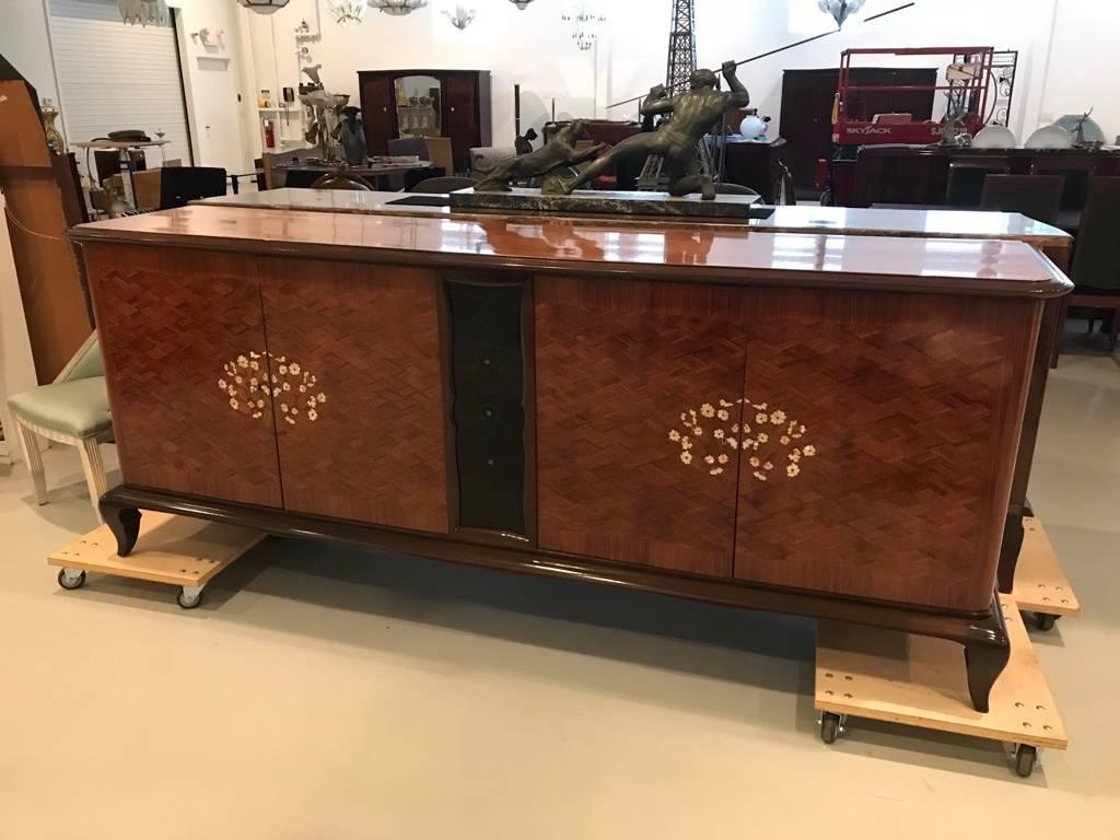 A stunning French Art Deco palisander marquetry with mother-of-pearl and black opaline glass accented sideboards, buffets or bar. Beautiful detail throughout, in the style of the master Jules Leleu. Very fine craftsmanship and finished interior,