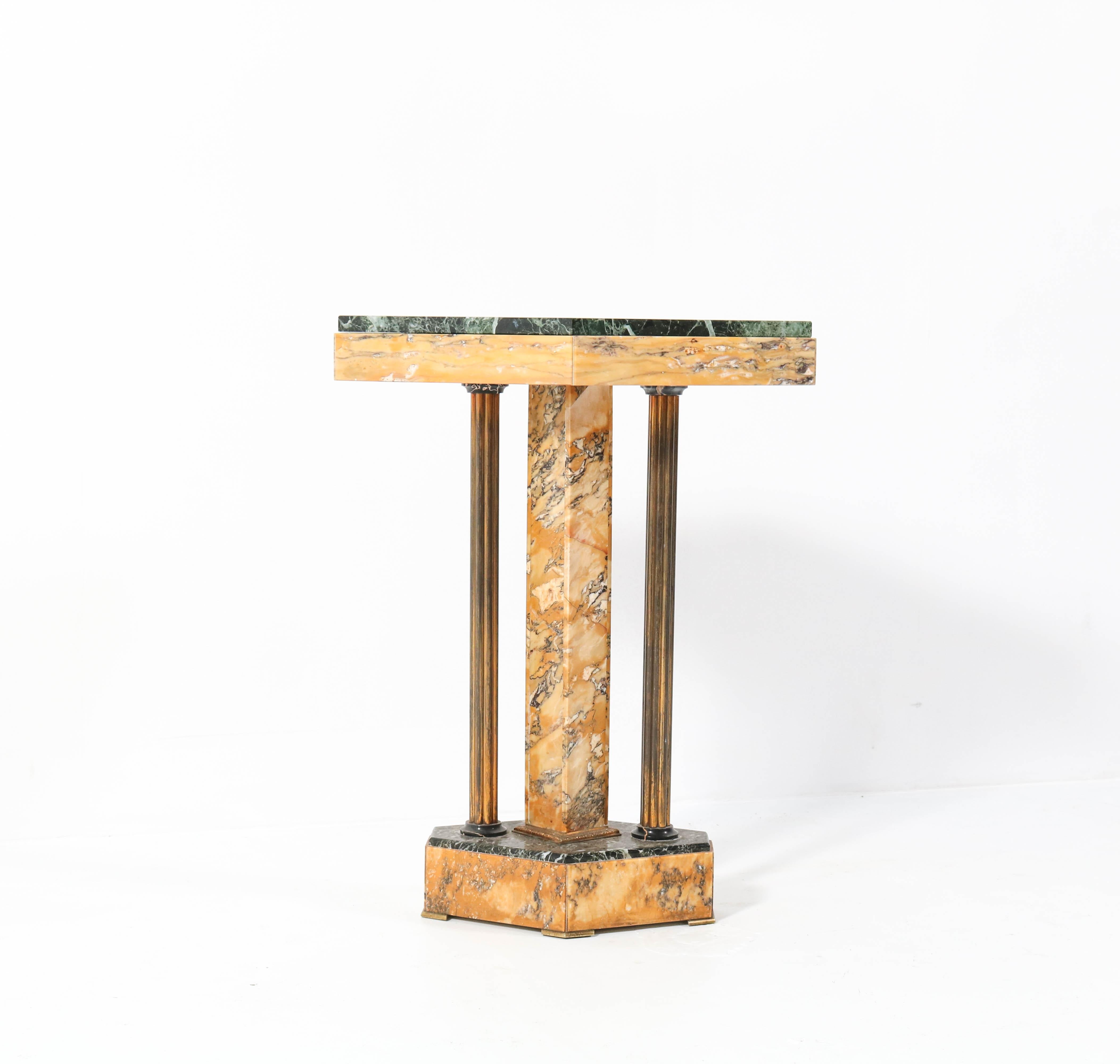 Magnificent and ultra rare Art Deco side table.
Striking French design from the 1930s.
Solid multicolored marble and brass base.
Patricia green marble top.
This wonderful piece of furniture is in very good condition and
has a beautiful patina.