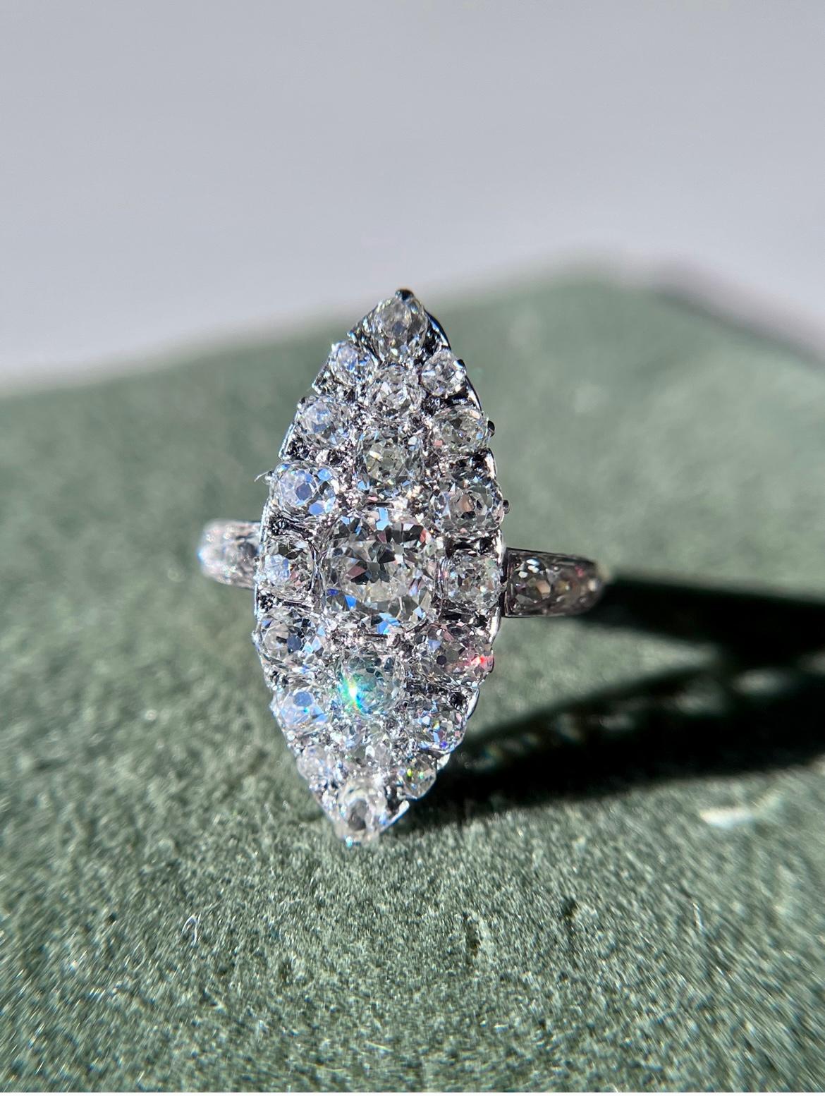 This Art Deco navette ring is a stunning example of early 20th-century jewelry. Set with a dazzling mixture of old mine cut and old European cut diamonds, this piece makes quite an impact! The diamonds are set in platinum and 18k yellow gold making