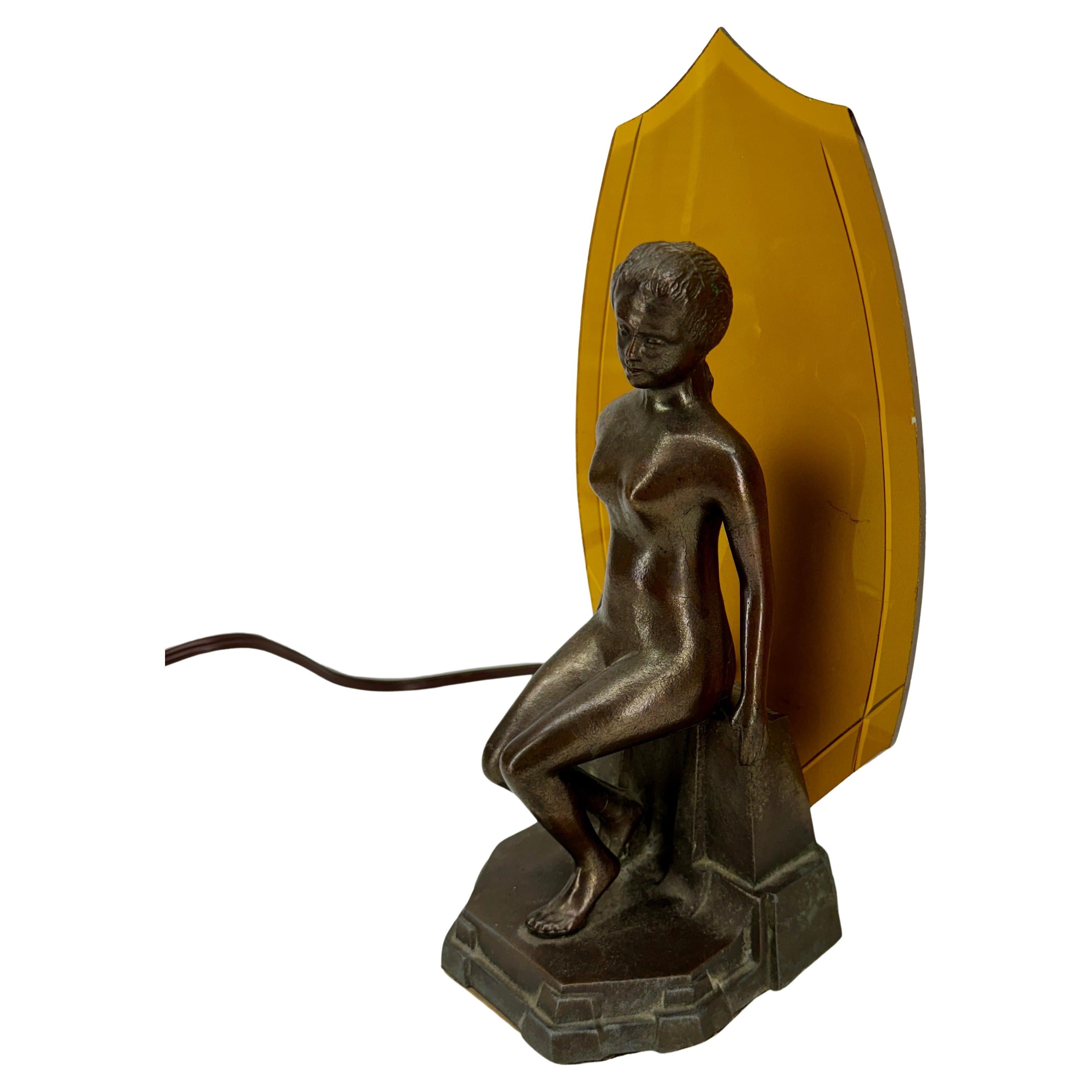 Art Deco Nude Boudoir Lamp, 1960's France 

Woman Figural Art Deco Table Lamp. Beautiful sitting lady. Separate original yellow glass piece behind her that illuminates when lit. 
