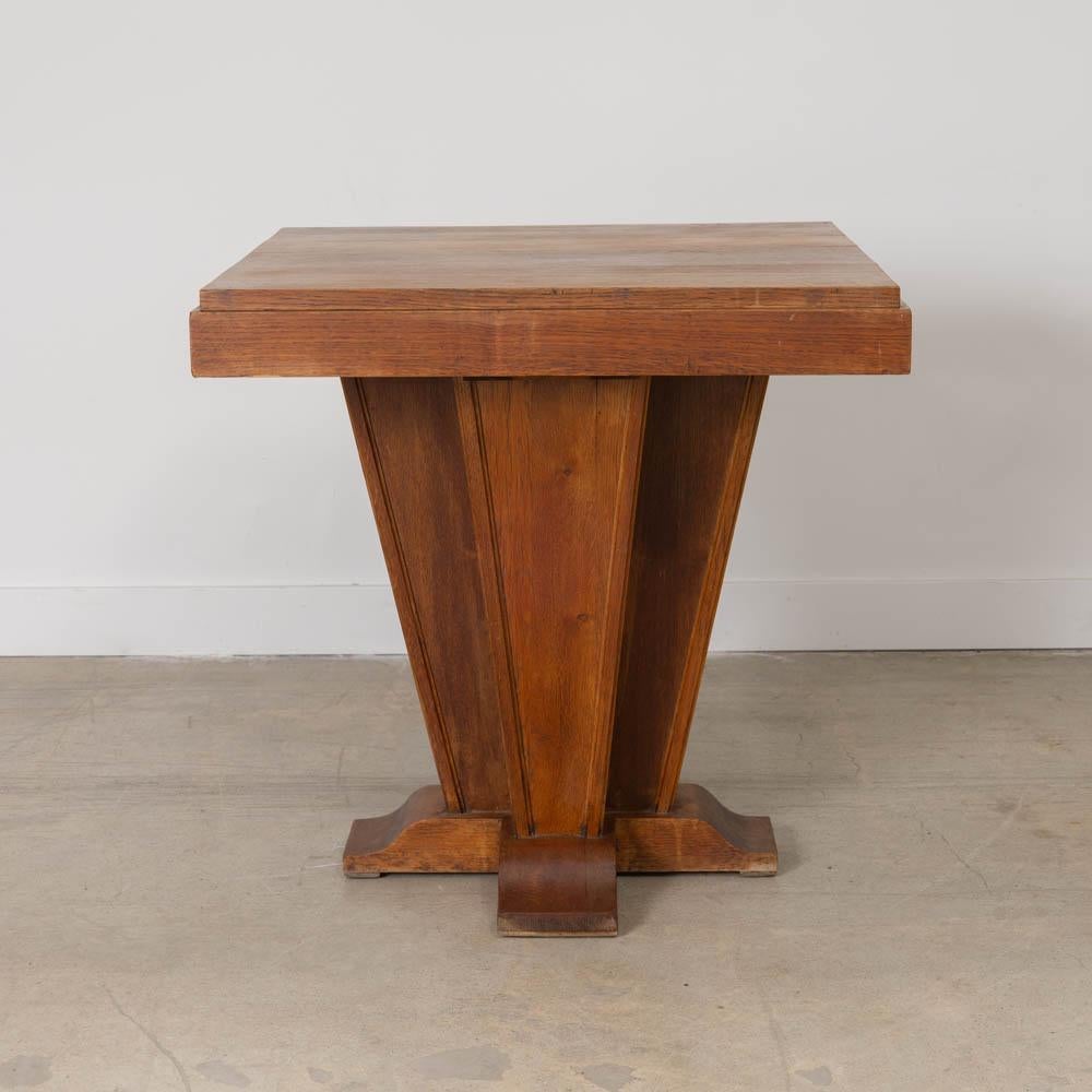 Stunning Art Deco side table from France, 1930s. Thick square top rests on a striking tapered base with four curved feet. Original finish shows nice natural grain, age, and patina. Striking piece, perfect as a side, game or center table.  