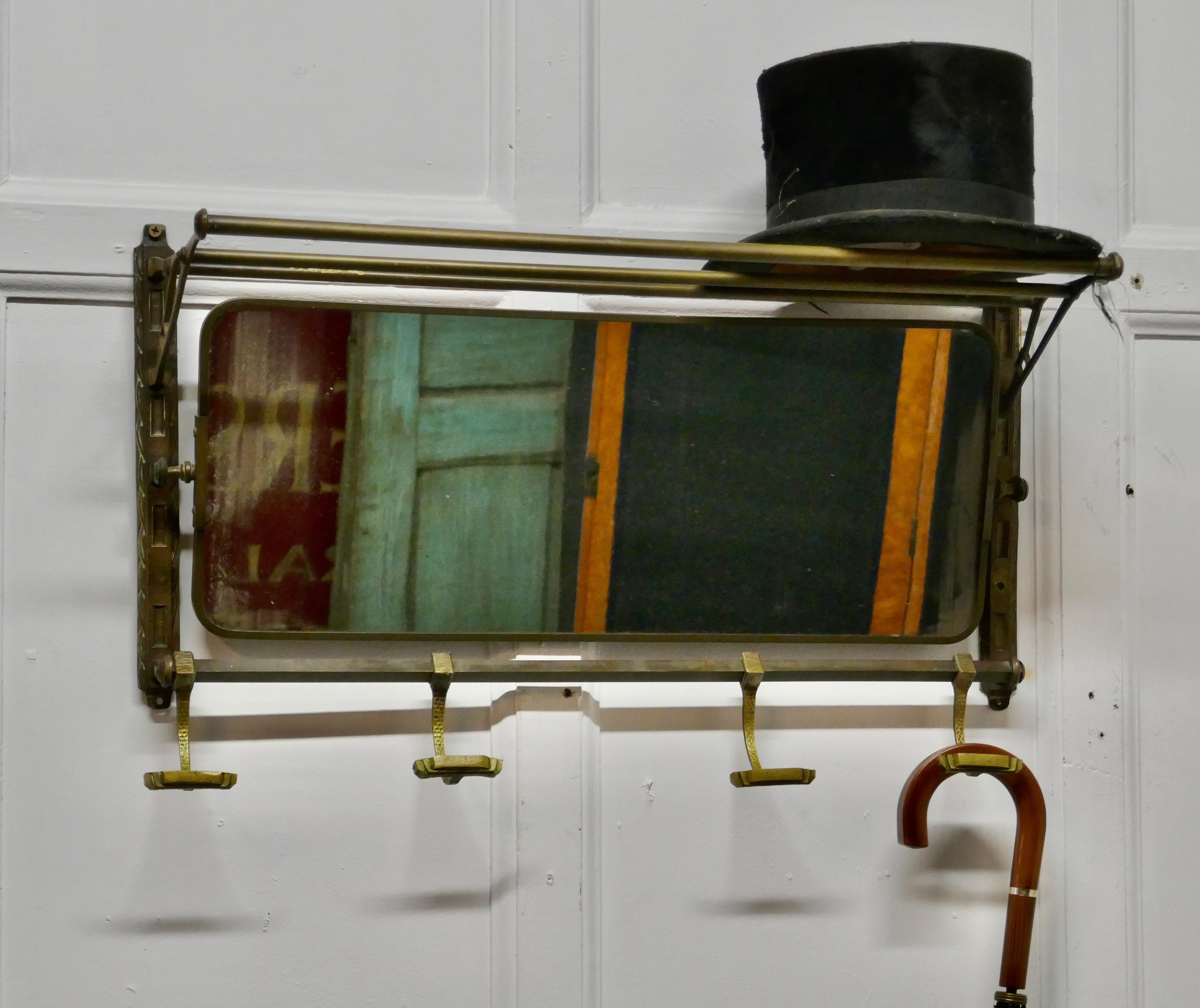 French Art Deco Odeon style Pullman mirror from a train

This Art Deco period brass train rack includes its original swivel mirror that adjusts to the proper angle for viewing, it has 4 sliding hooks and an upper shelf
Originally used in a French
