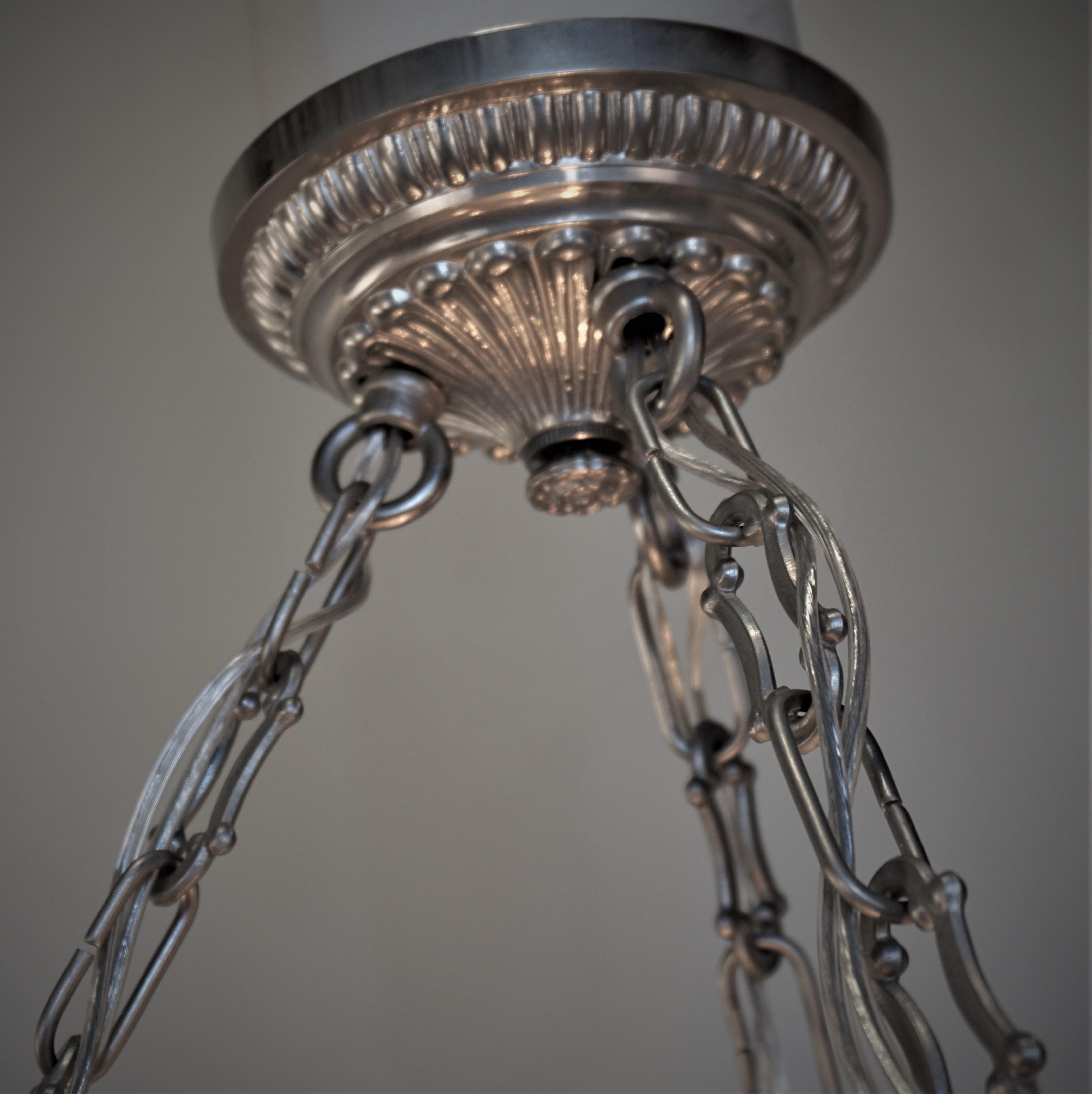 A wonderful Art Deco chandelier. Masterfully crafted by the world renowned Verlys Glass in Rouen, France, this elegant opalescent glass chandelier features a beautiful flying bird and fish design.